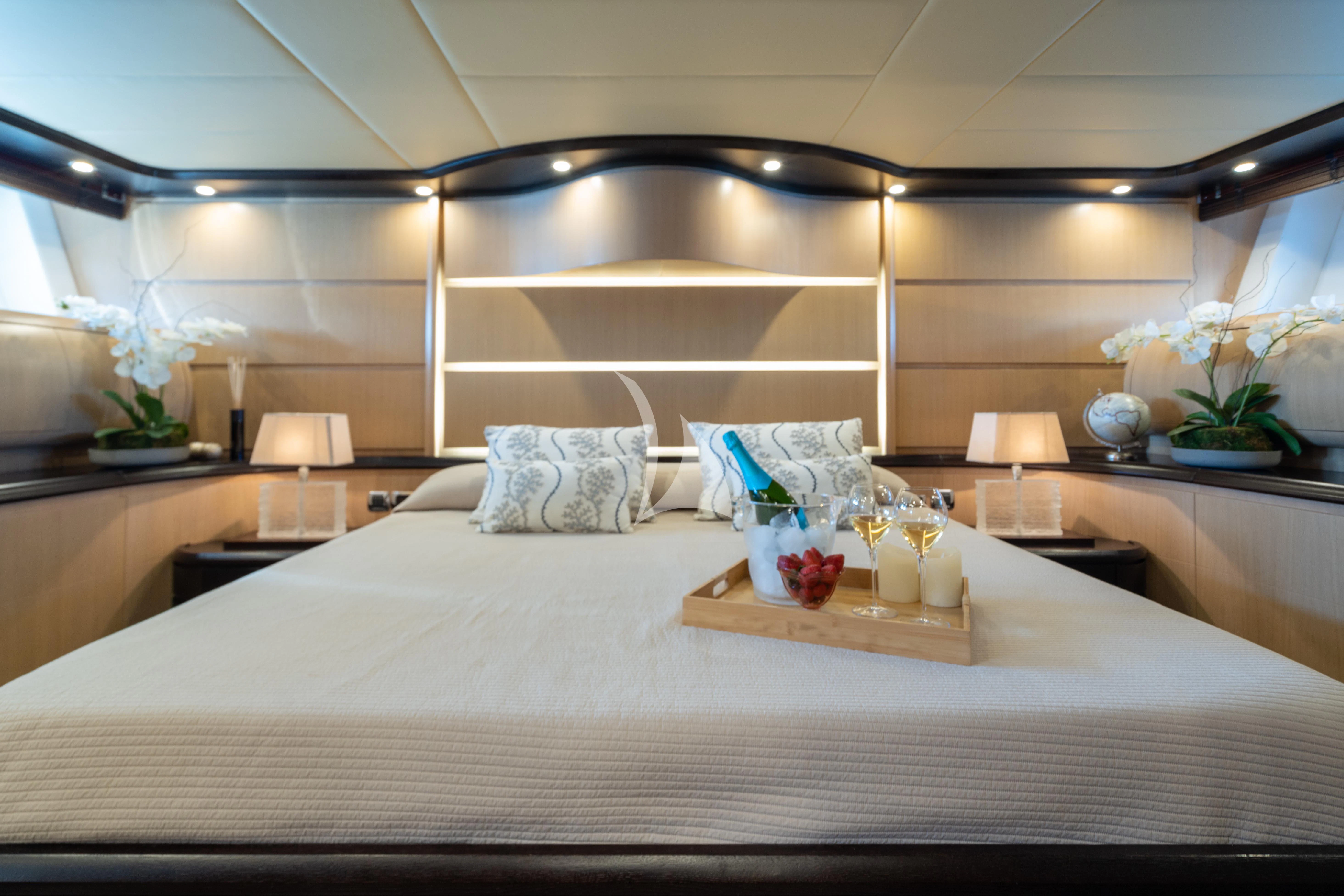 a bed with white sheets and pillows aboard DOLCE VITA IV Yacht for Sale