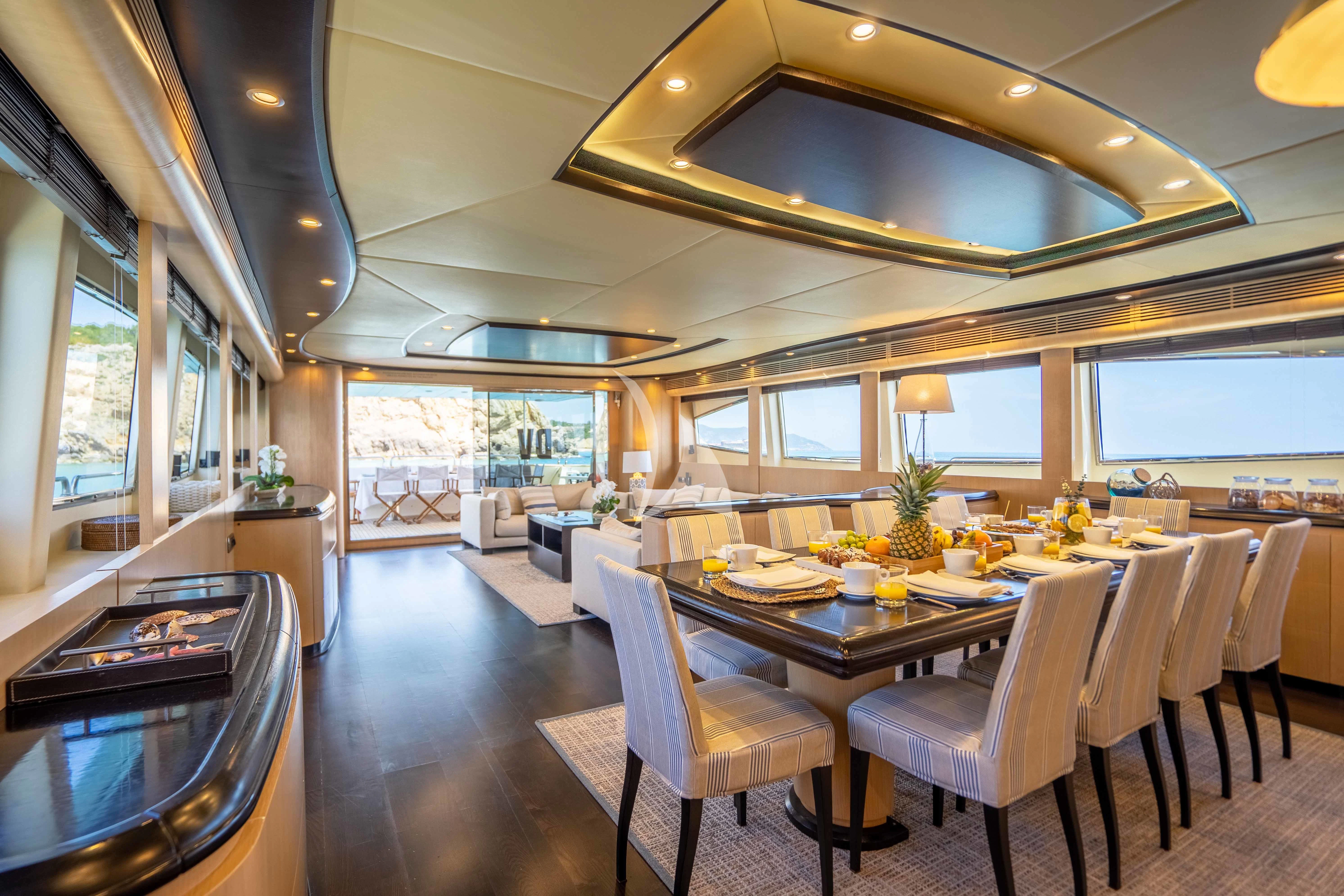 a large kitchen with a dining table aboard DOLCE VITA IV Yacht for Sale