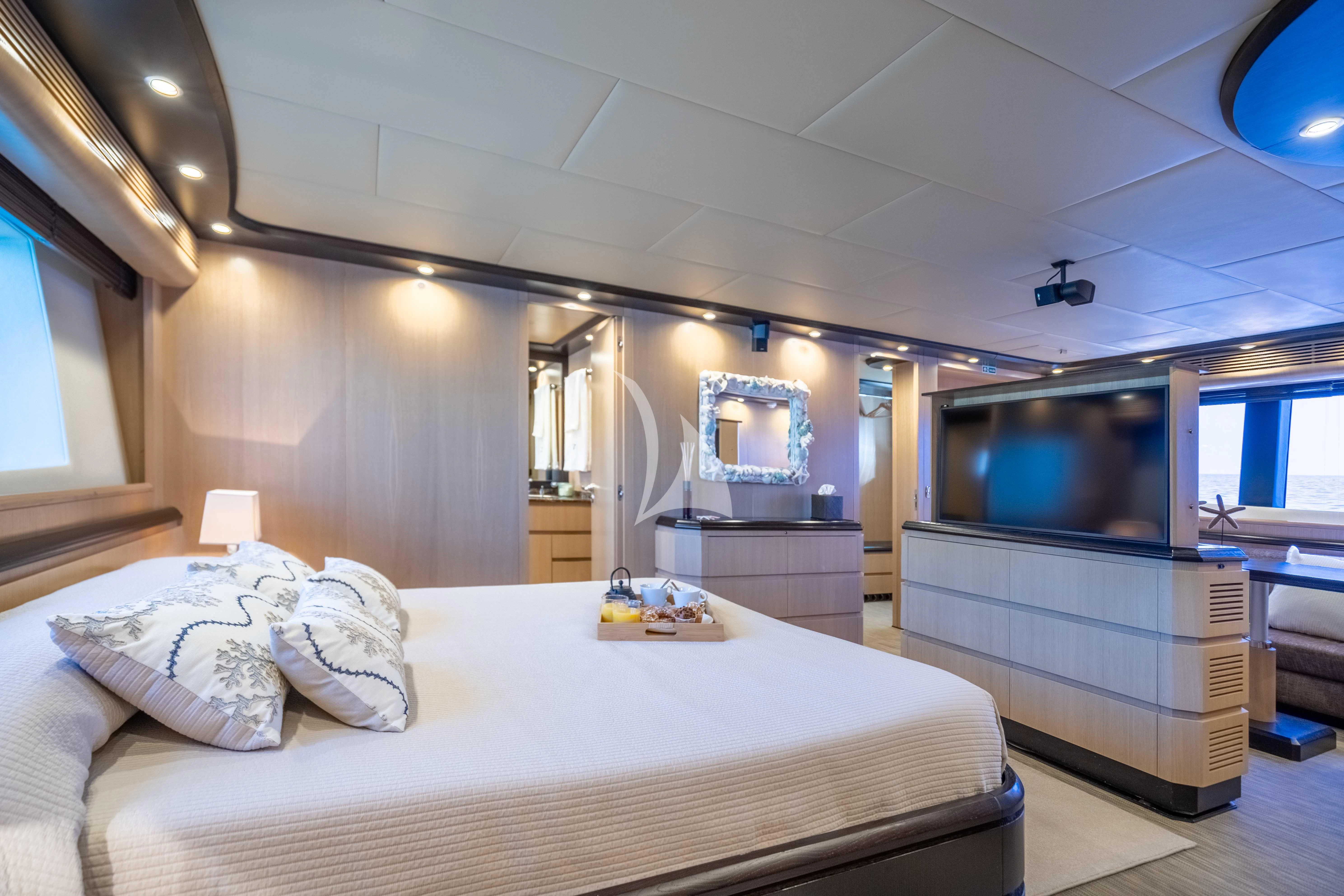a bedroom with a large bed aboard DOLCE VITA IV Yacht for Sale