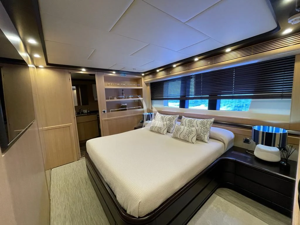 a room with a bed and a window aboard DOLCE VITA IV Yacht for Sale
