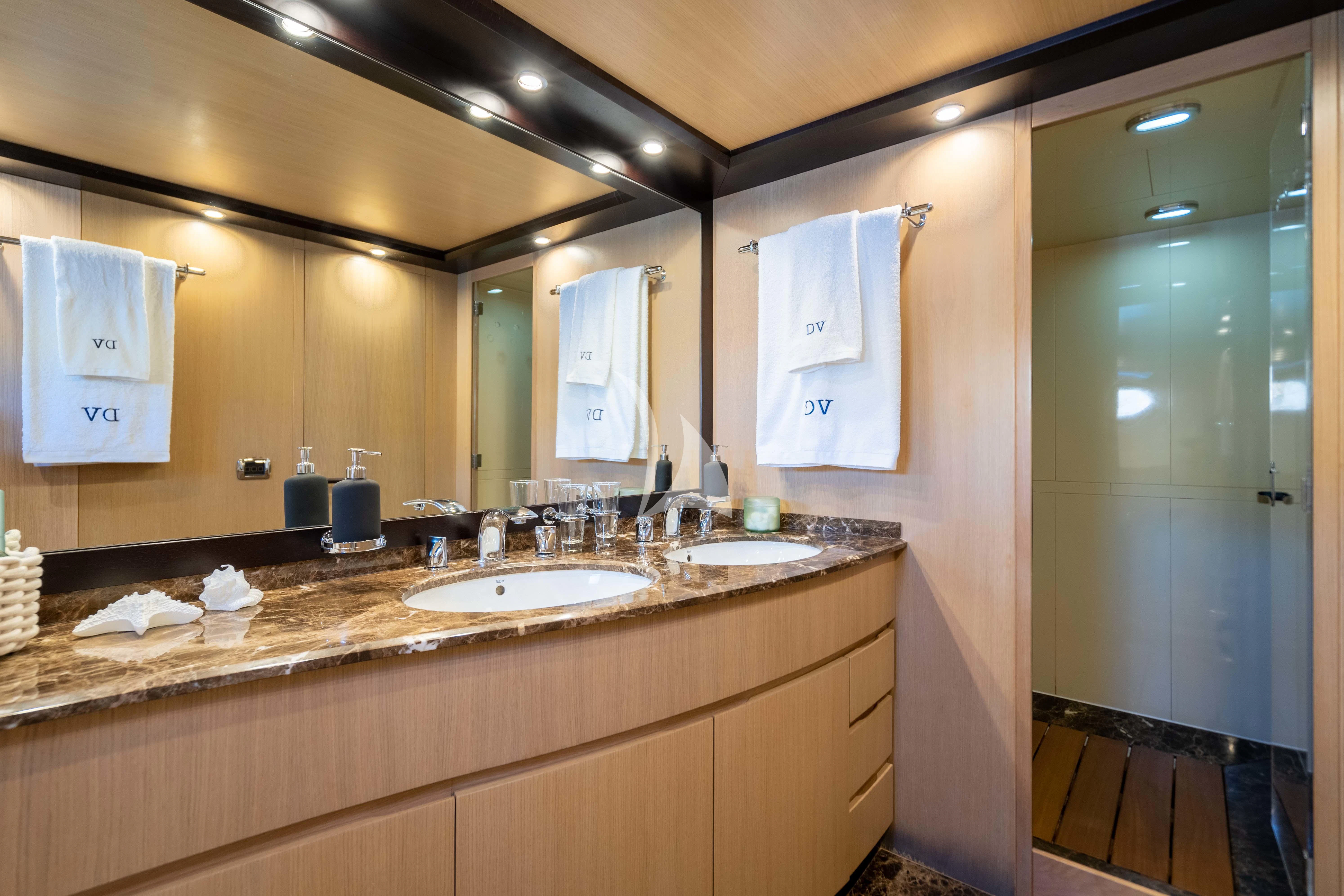 a bathroom with a large mirror aboard DOLCE VITA IV Yacht for Sale
