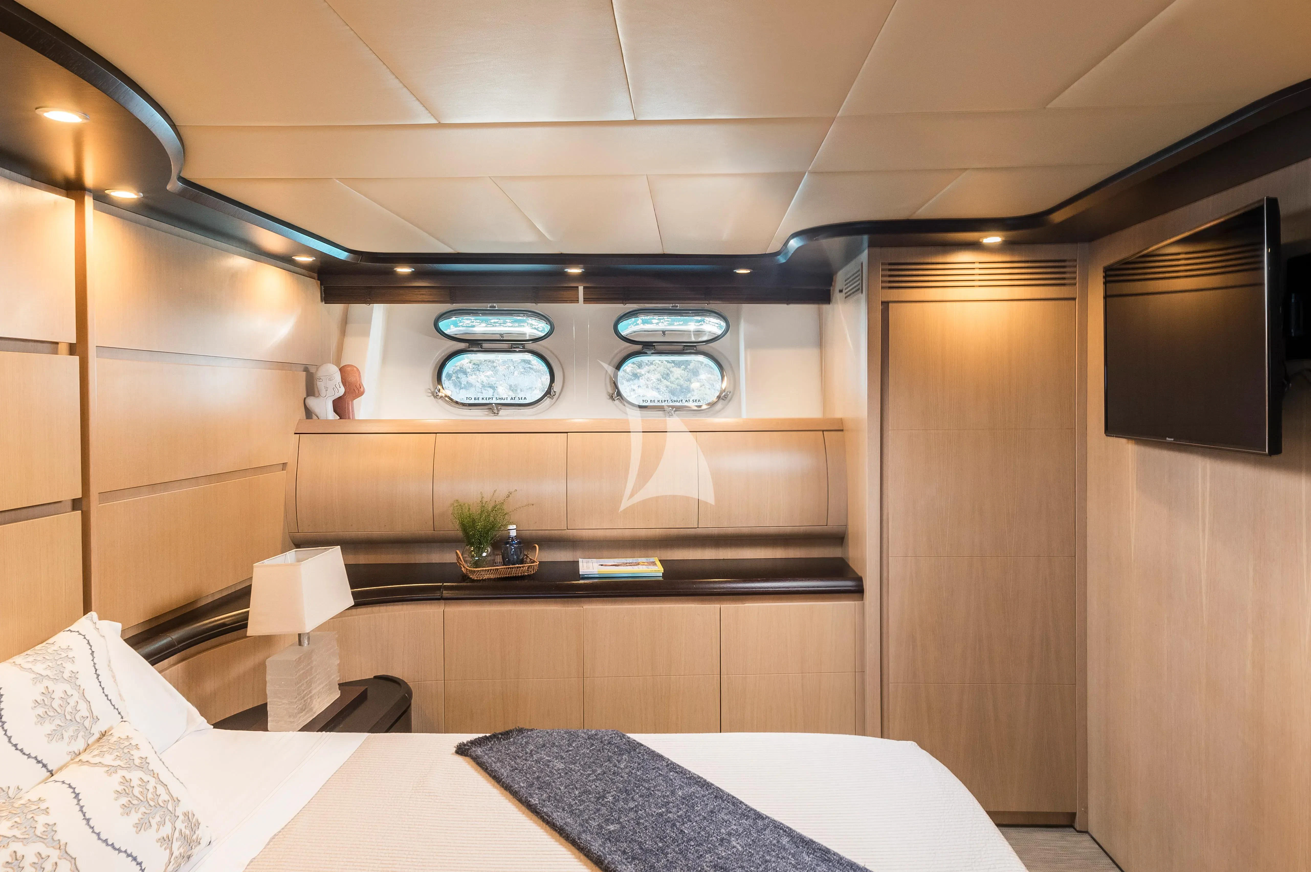 a room with a table and a bed aboard DOLCE VITA IV Yacht for Sale