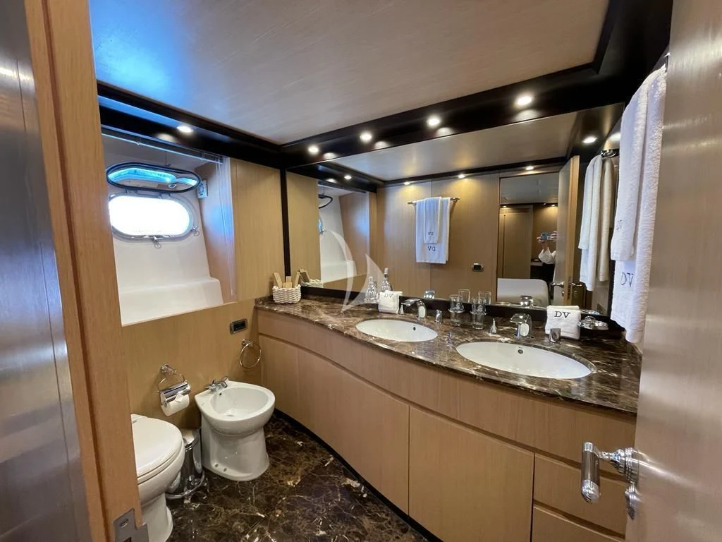 a bathroom with a large mirror aboard DOLCE VITA IV Yacht for Sale