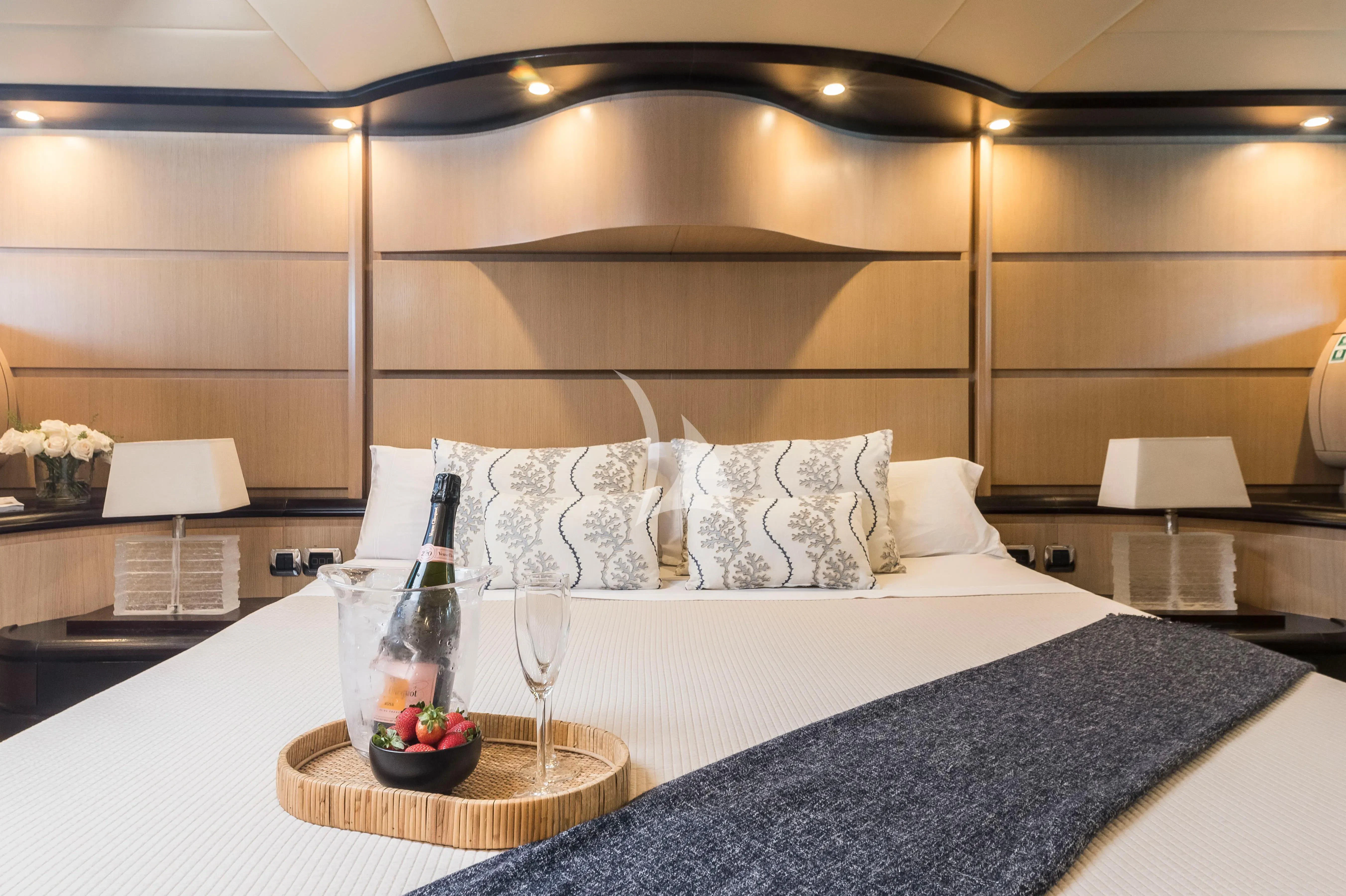 a bed with white sheets and pillows aboard DOLCE VITA IV Yacht for Sale