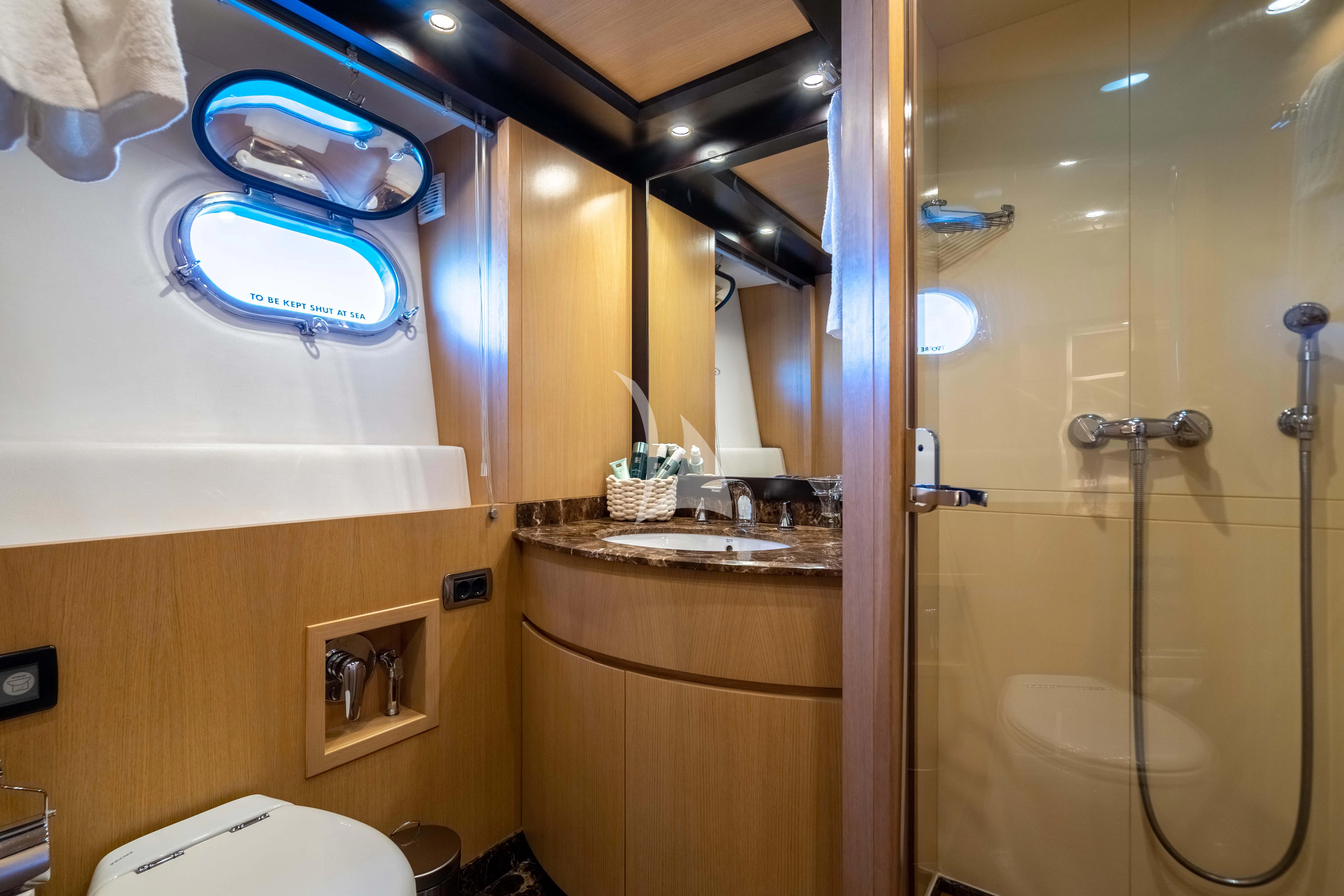 a bathroom with a glass shower aboard DOLCE VITA IV Yacht for Sale