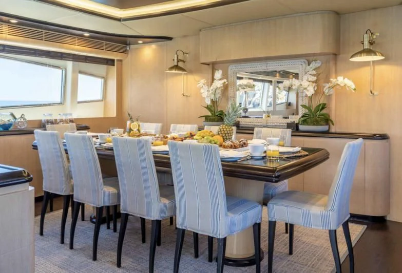a dining room with white chairs aboard DOLCE VITA IV Yacht for Sale
