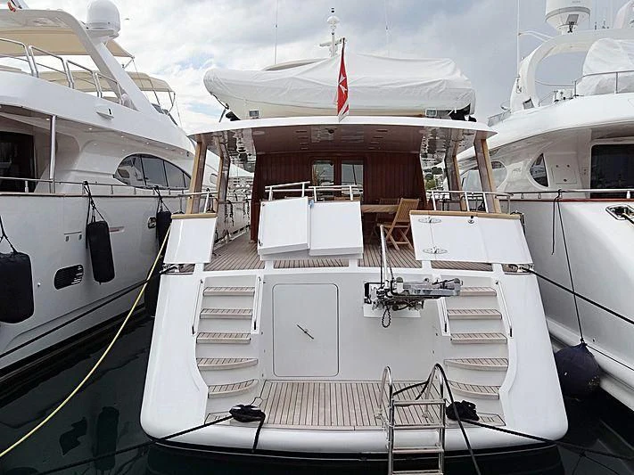 a boat with a deck and chairs aboard LIBERTUS Yacht for Sale