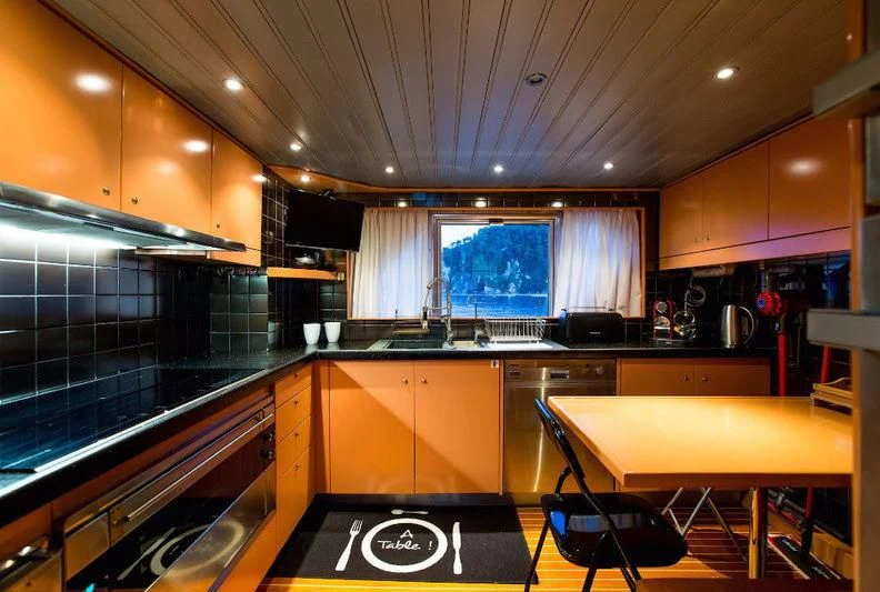 a kitchen with a large window aboard LIBERTUS Yacht for Sale