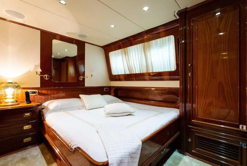 a hotel room with a bed aboard LIBERTUS Yacht for Sale
