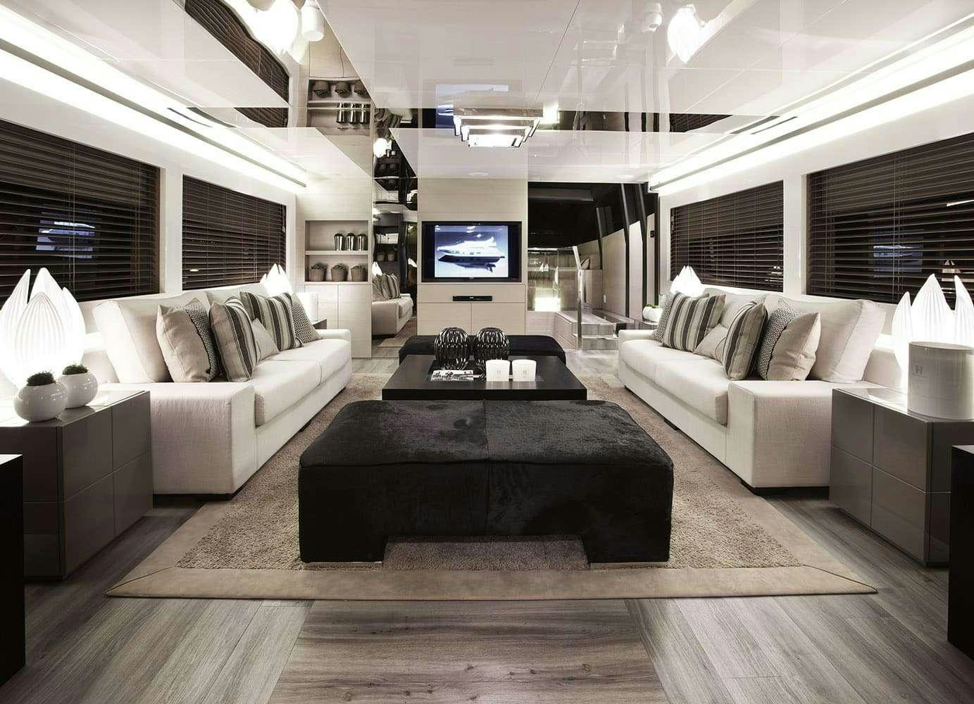 a living room with a large screen aboard FINALLY Yacht for Charter