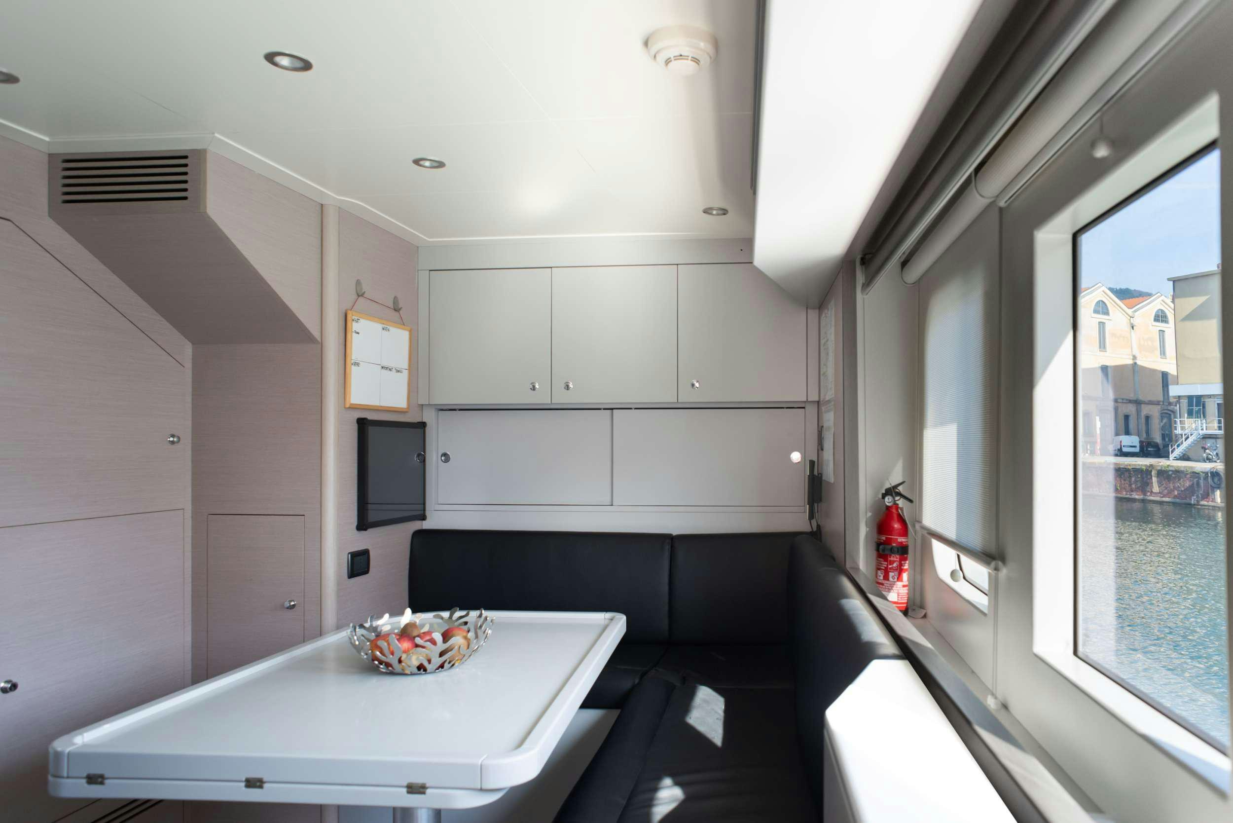 a kitchen with a table and a window aboard GRANIL Yacht for Sale