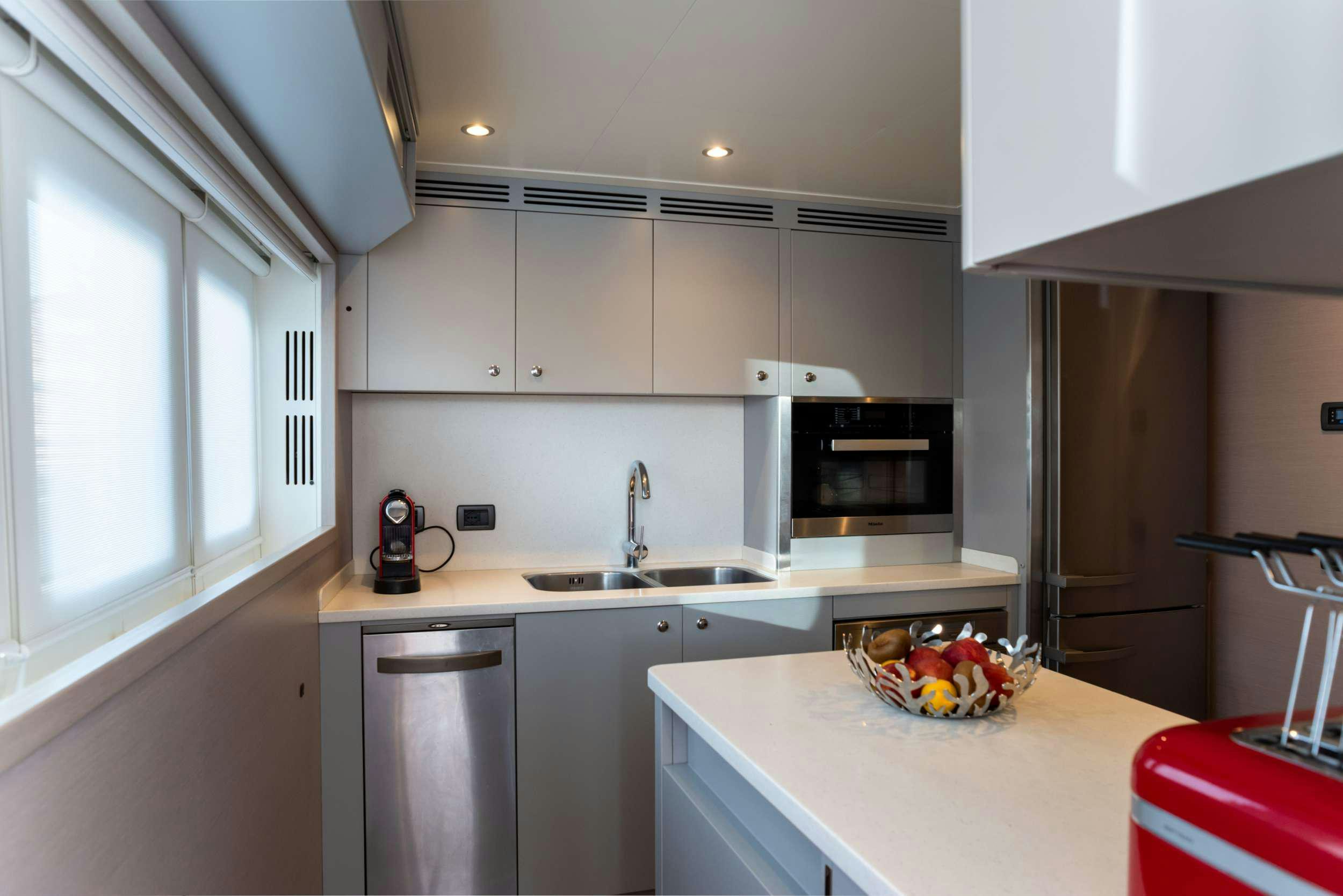 a kitchen with white cabinets aboard GRANIL Yacht for Sale