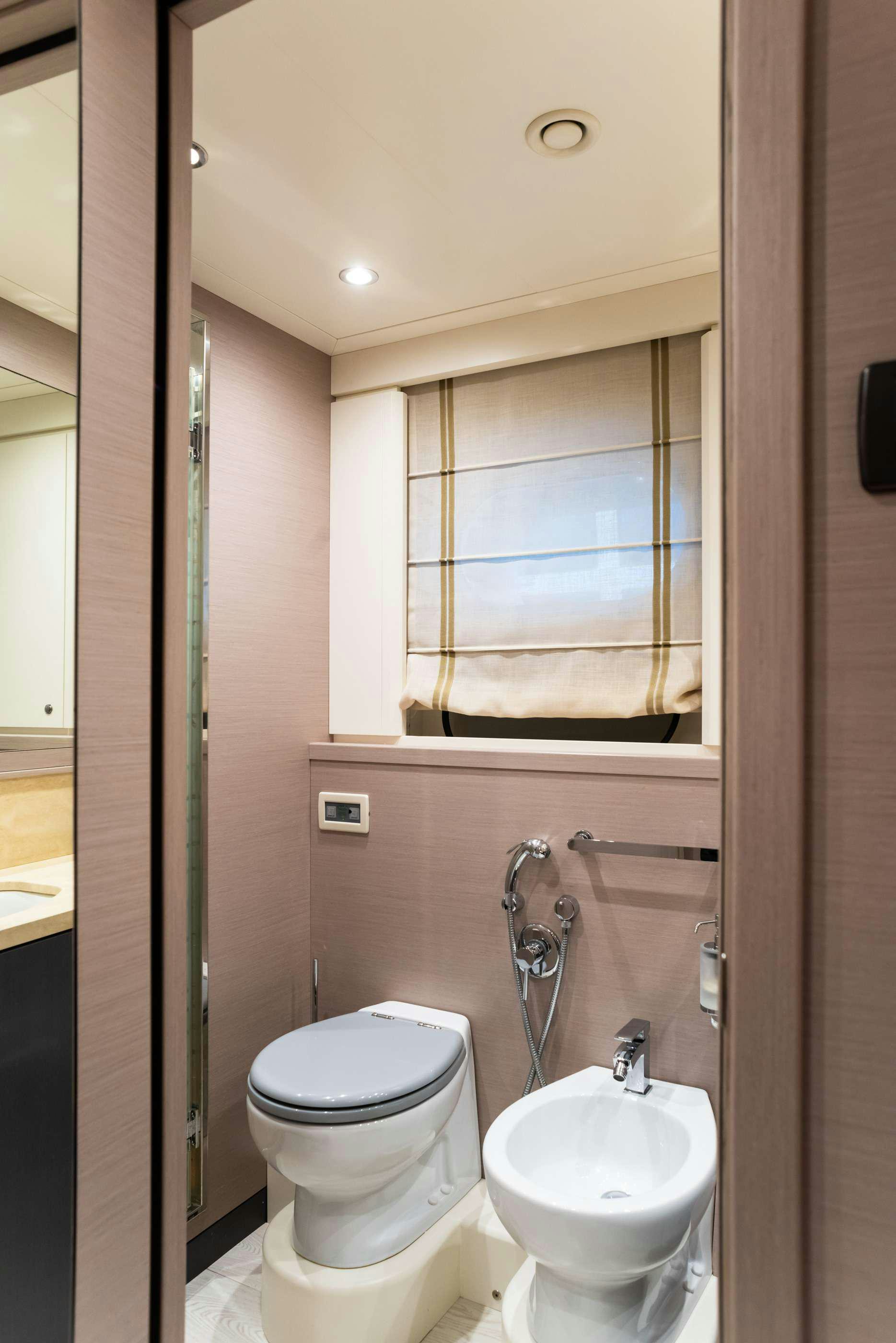 a bathroom with a toilet and a sink aboard GRANIL Yacht for Sale