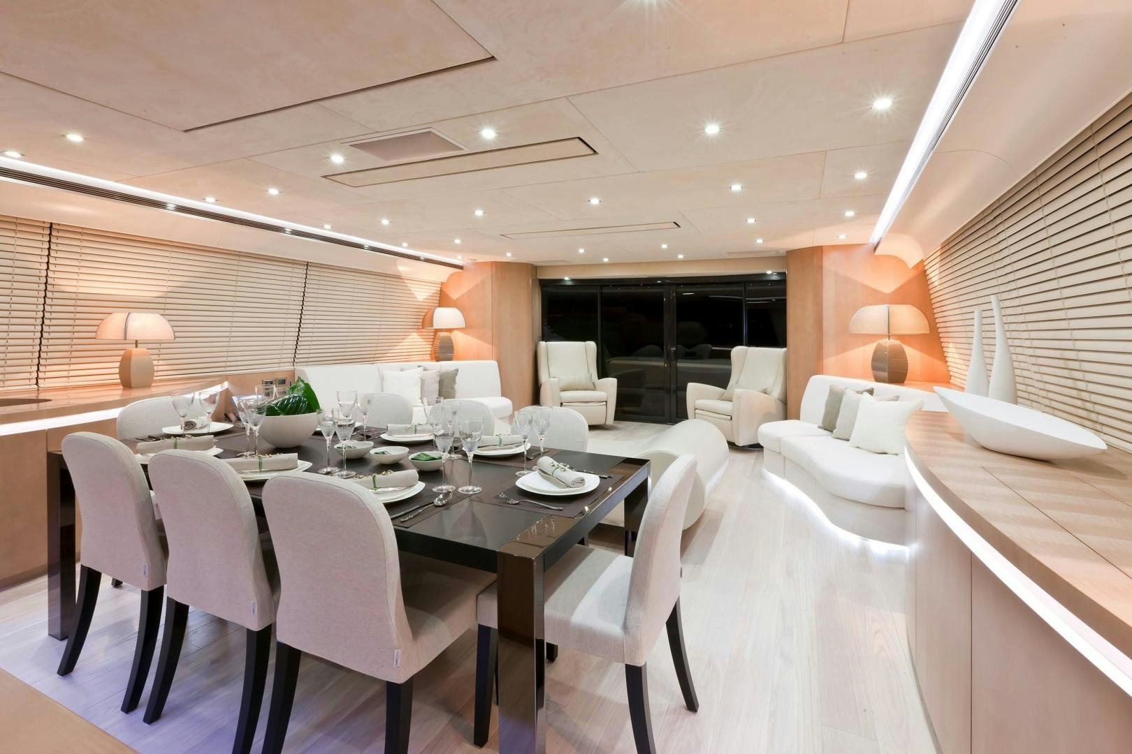 a room with tables and chairs aboard KUIKILA Yacht for Sale