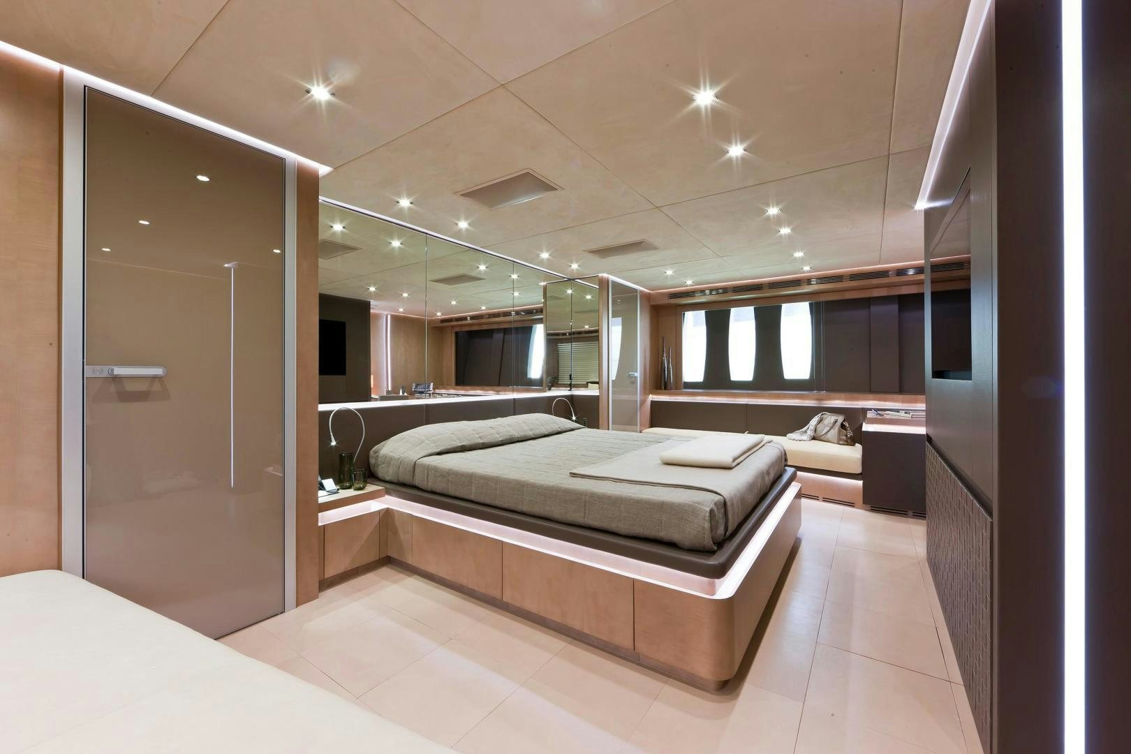a room with a bed and a mirror aboard KUIKILA Yacht for Sale