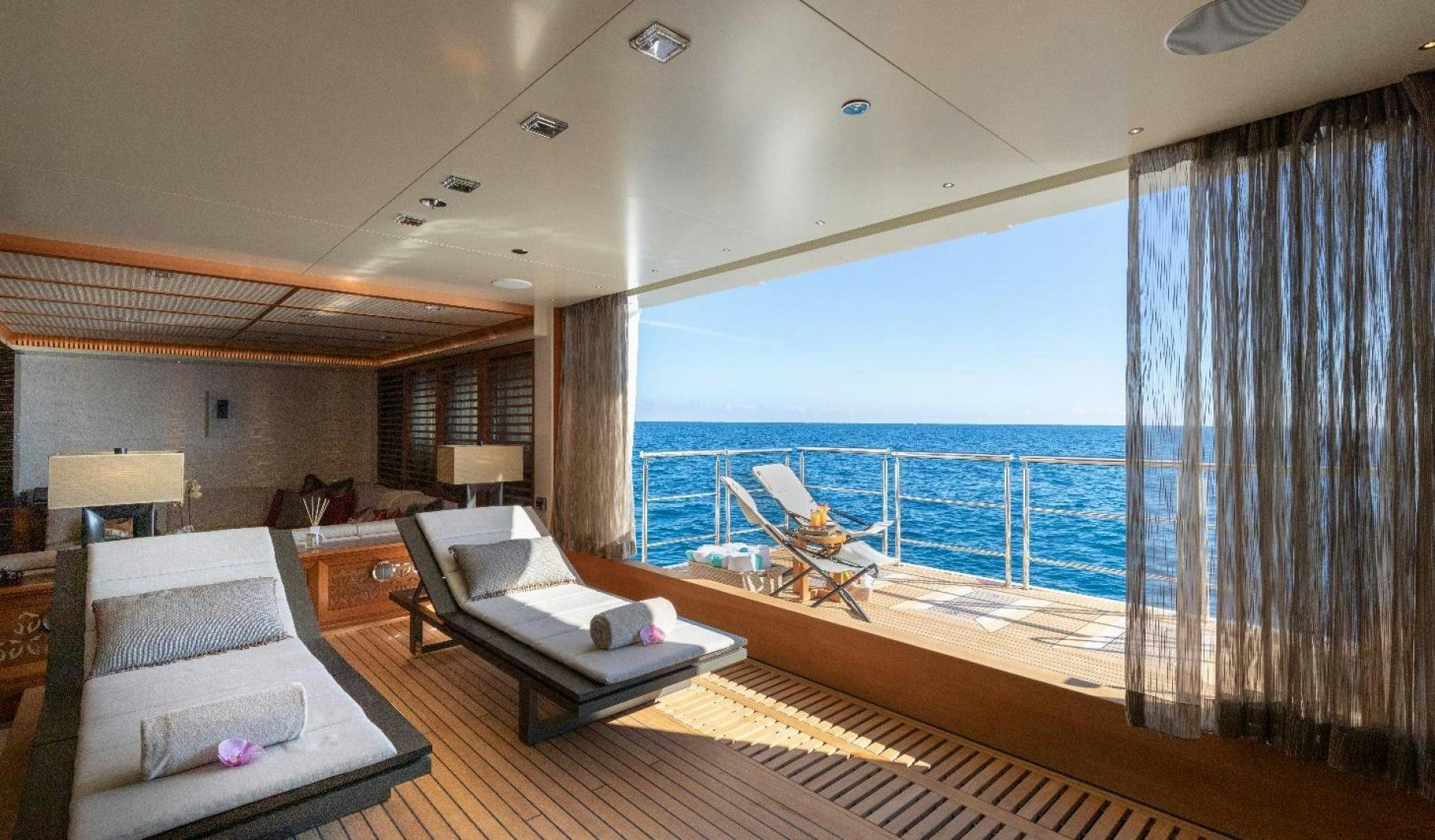 a large room with a balcony aboard QUANTUM OF SOLACE Yacht for Sale