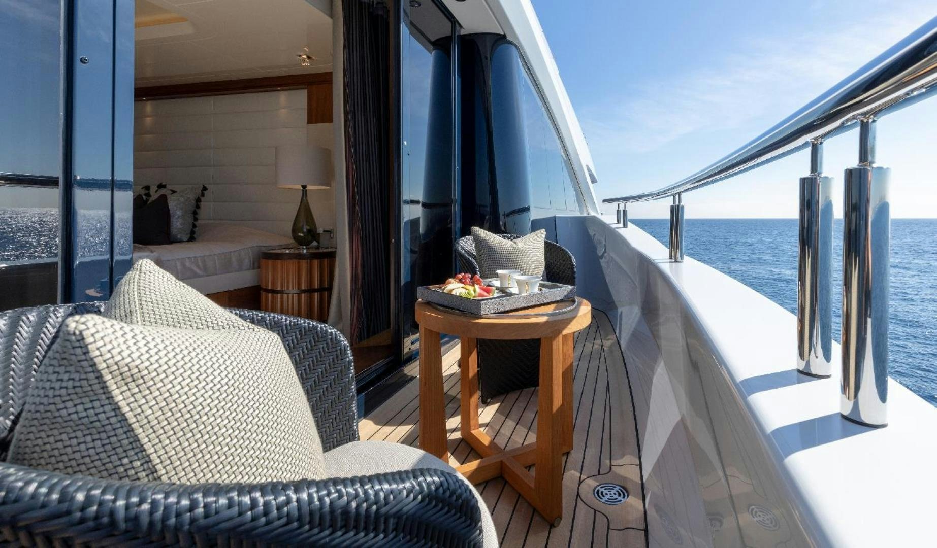 a room with a couch and a table and a chair aboard QUANTUM OF SOLACE Yacht for Sale