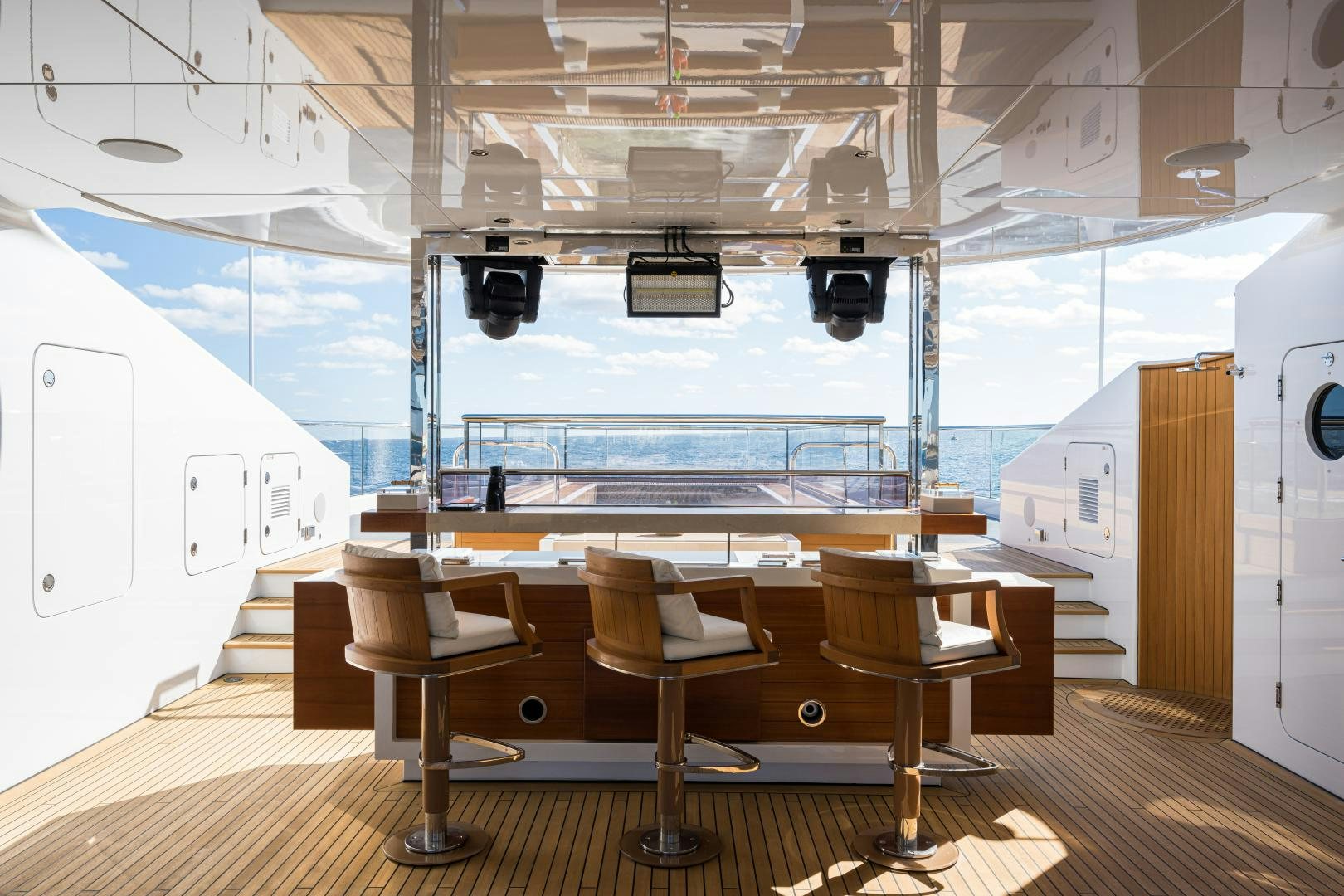 a room with a view of the ocean and the deck aboard QUANTUM OF SOLACE Yacht for Sale
