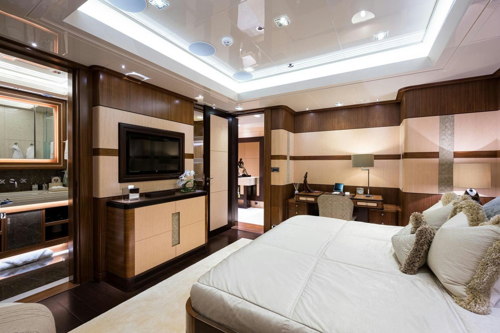 a bedroom with a bed and a tv aboard QUANTUM OF SOLACE Yacht for Sale