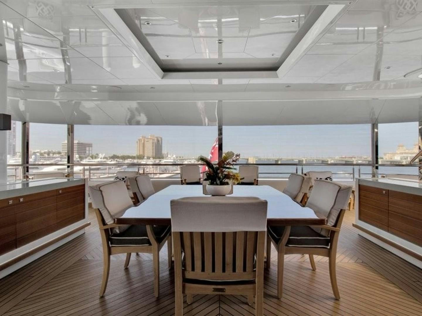 a room with tables and chairs aboard QUANTUM OF SOLACE Yacht for Sale