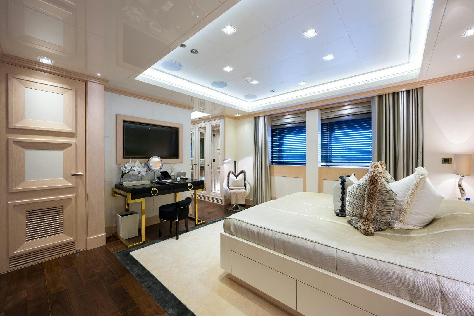 a bedroom with a bed and desk aboard QUANTUM OF SOLACE Yacht for Sale