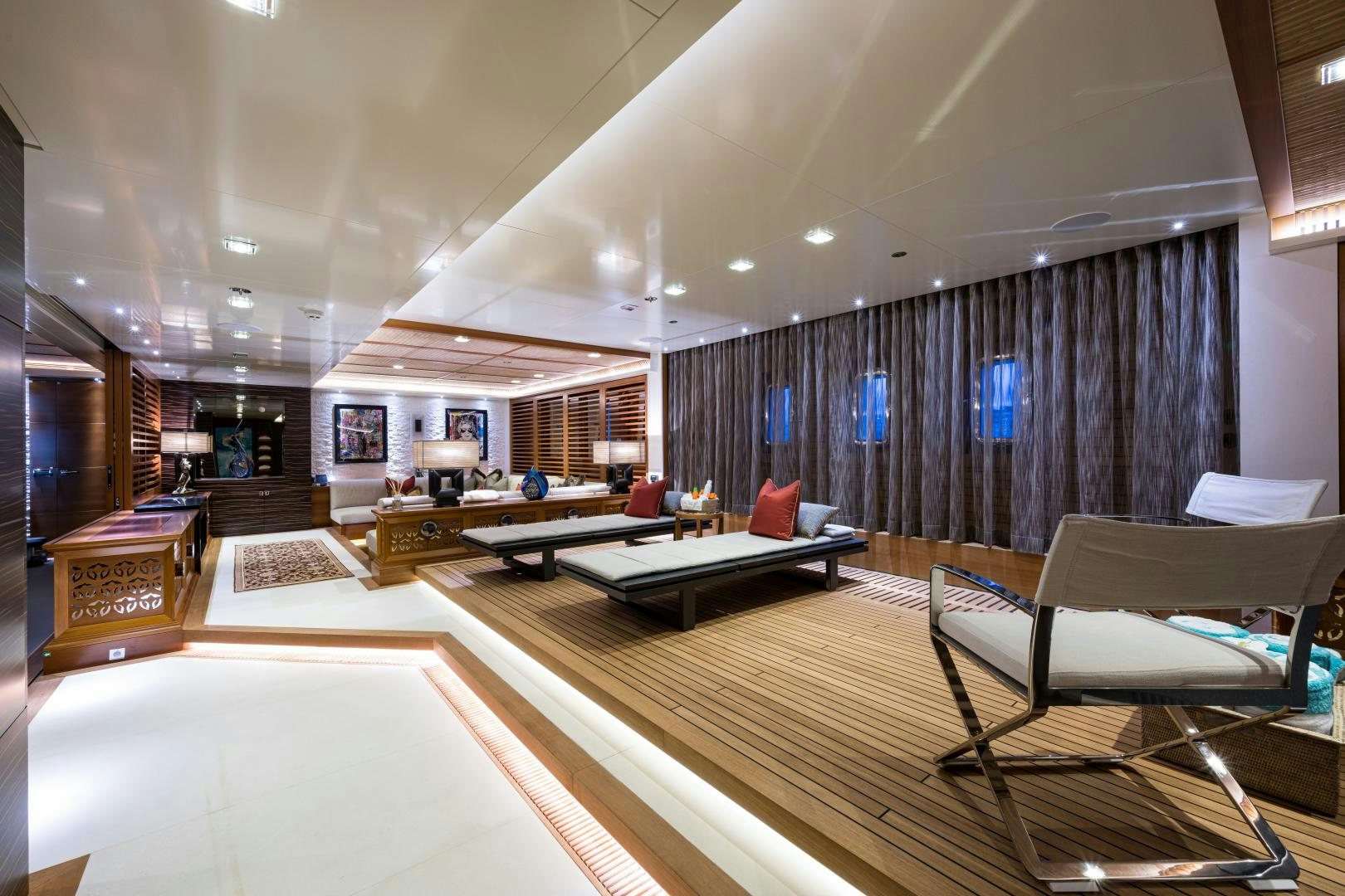 a room with a table chairs and a large window aboard QUANTUM OF SOLACE Yacht for Sale