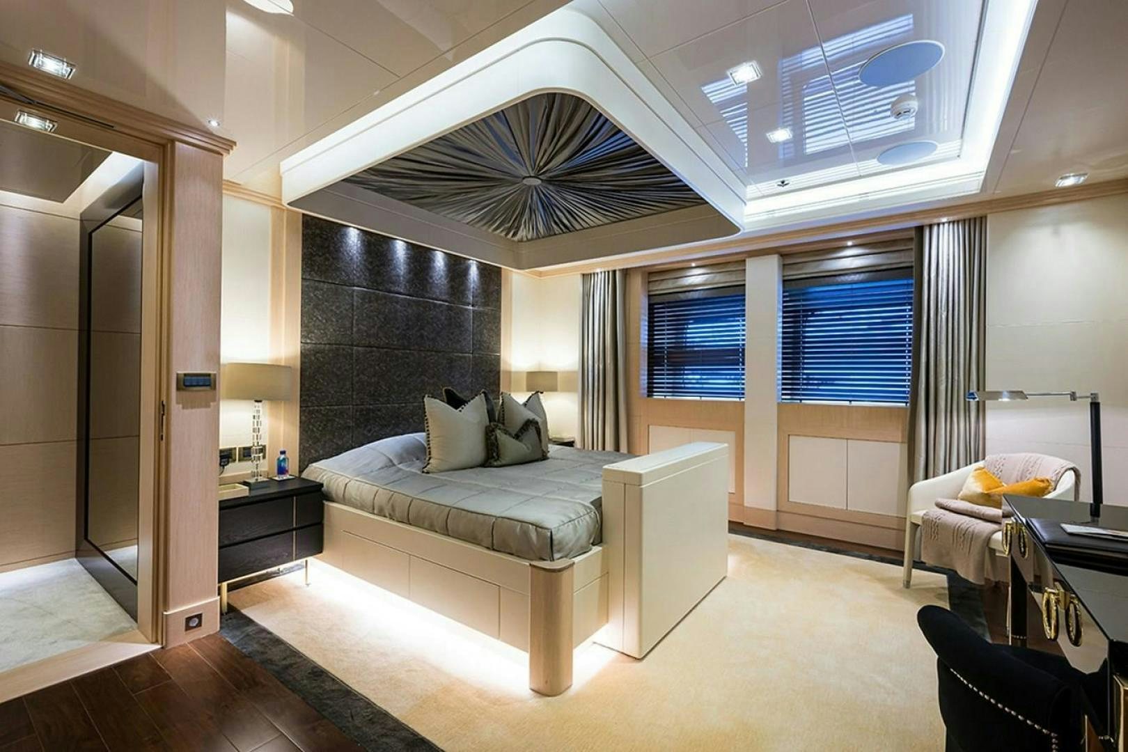 a room with a bed and a large window aboard QUANTUM OF SOLACE Yacht for Sale