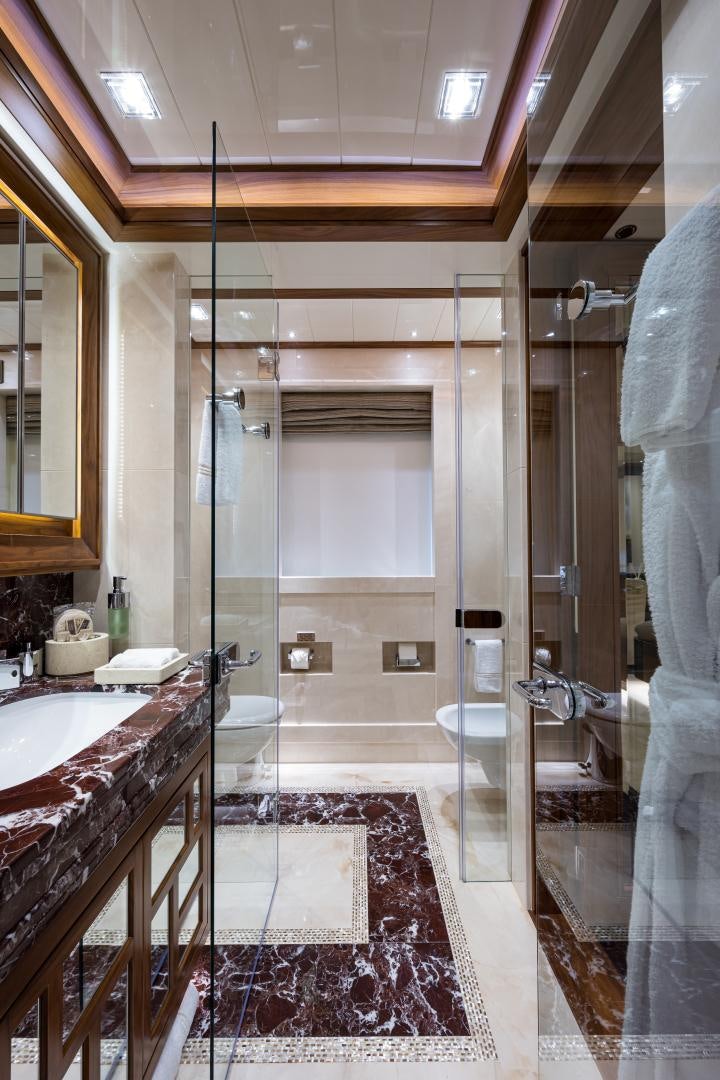 a bathroom with a shower and sink aboard QUANTUM OF SOLACE Yacht for Sale