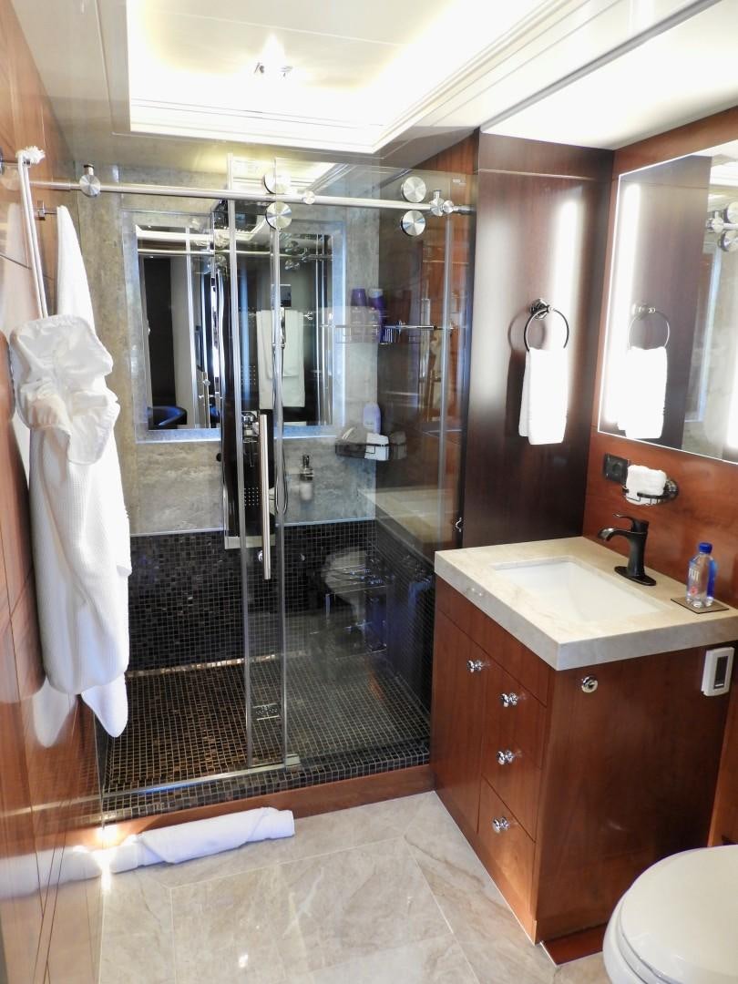 a bathroom with a shower unit and sink aboard QUANTUM OF SOLACE Yacht for Sale