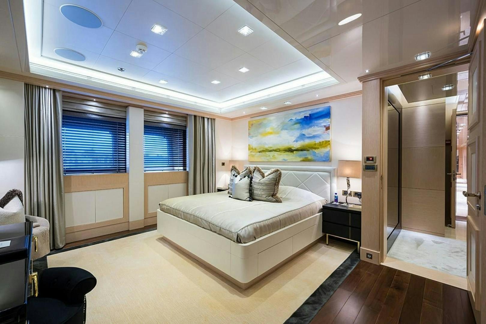 a bedroom with a bed and a desk aboard QUANTUM OF SOLACE Yacht for Sale