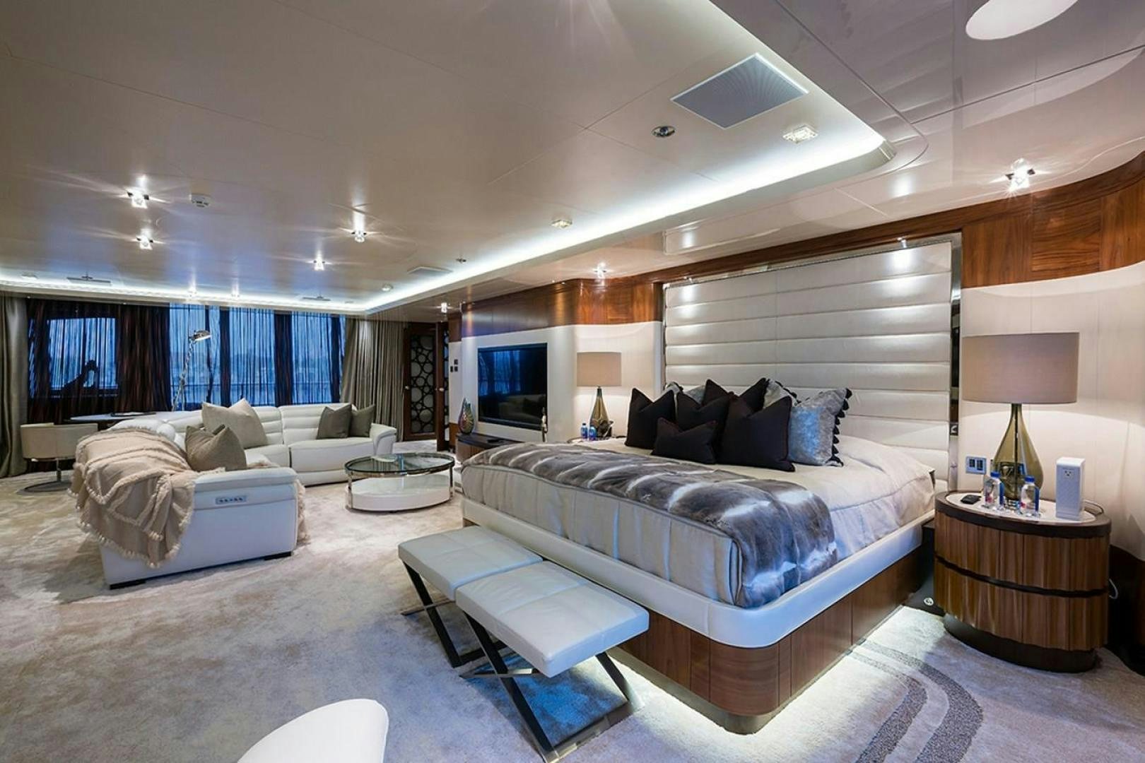 a living room with a large couch aboard QUANTUM OF SOLACE Yacht for Sale