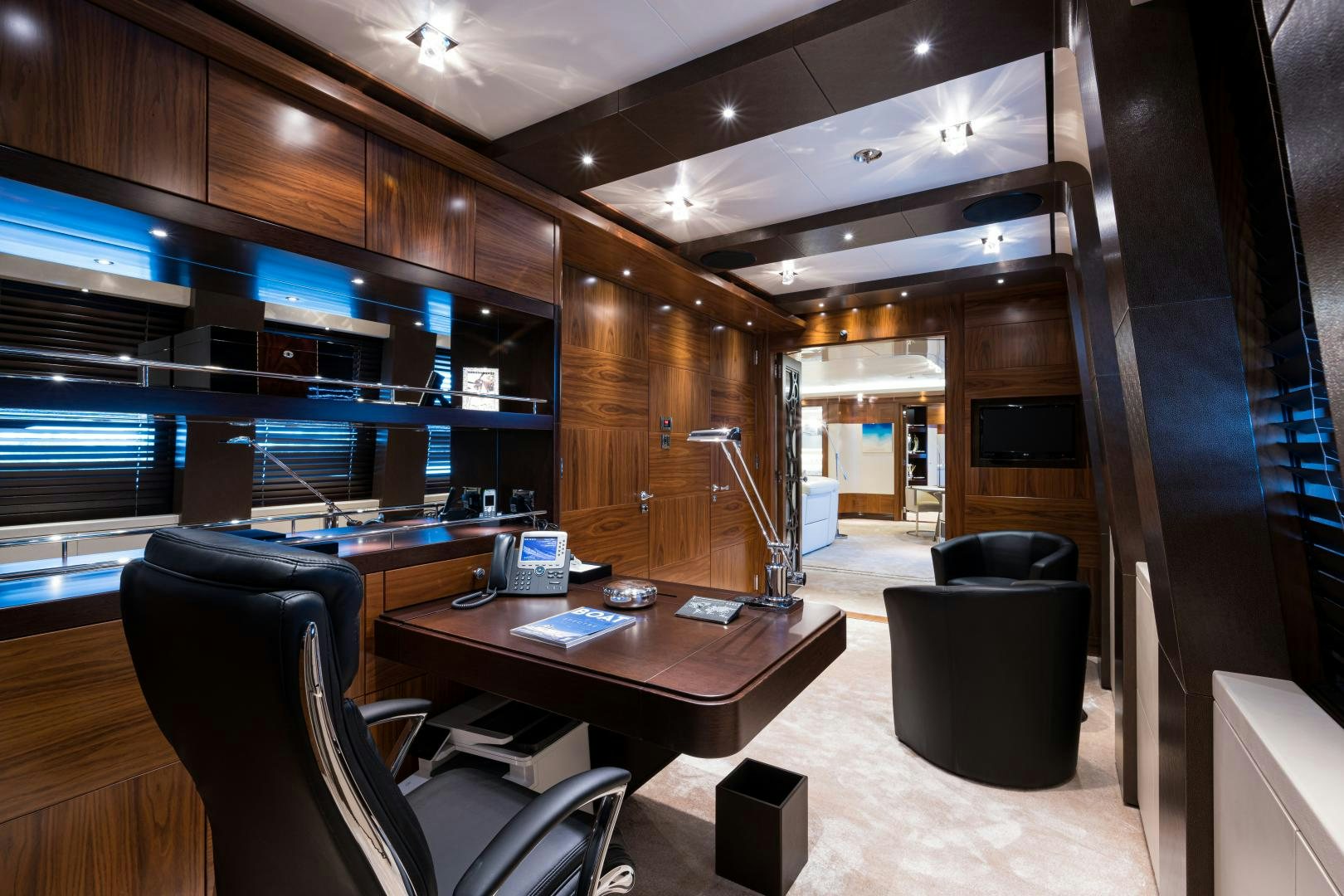 a room with a table chairs and a computer aboard QUANTUM OF SOLACE Yacht for Sale