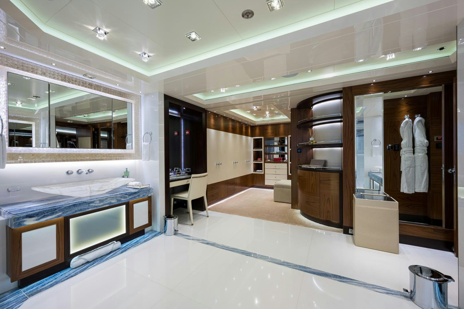 a large bathroom with a large countertop and a large mirror aboard QUANTUM OF SOLACE Yacht for Sale