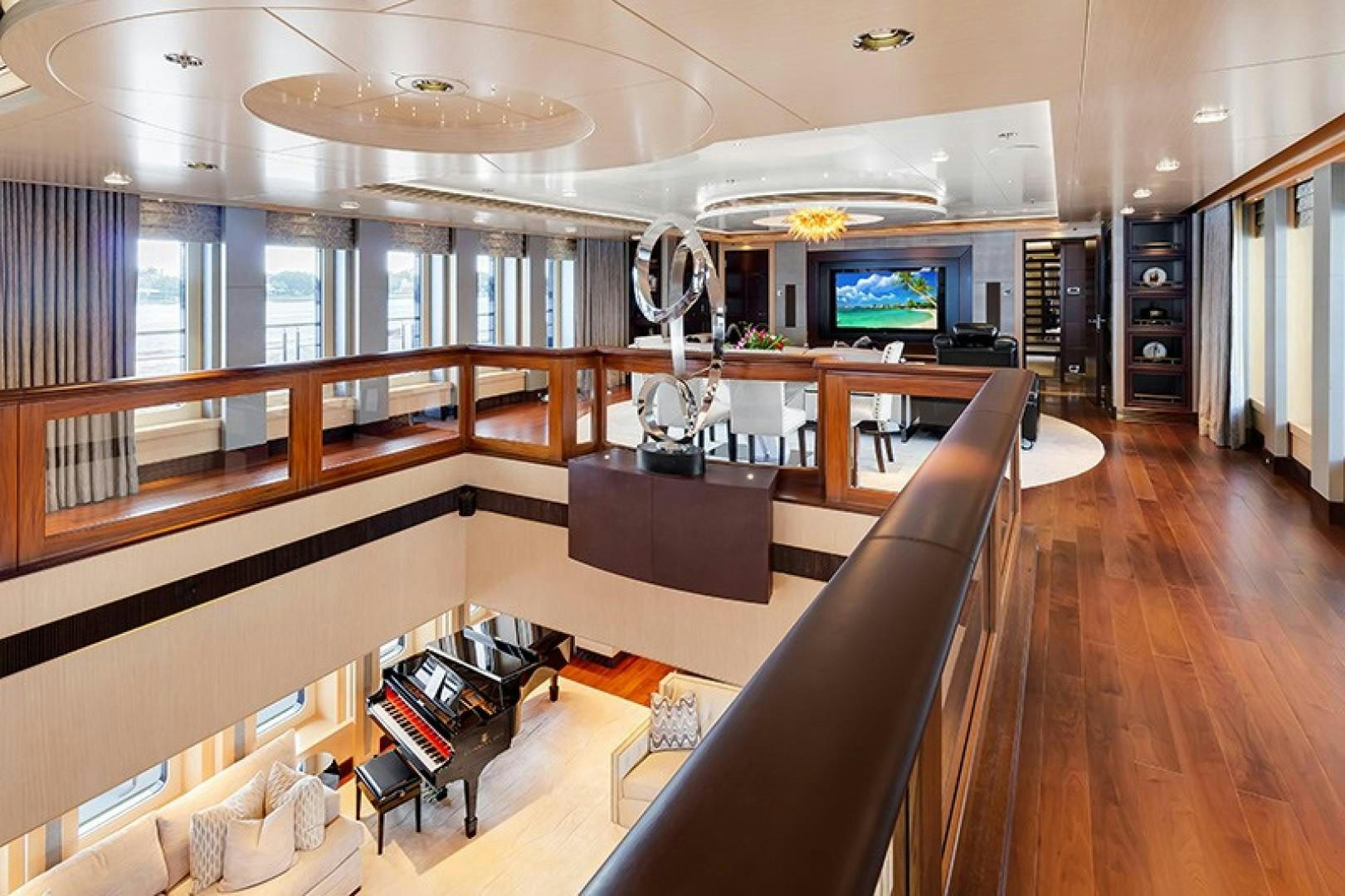 a room with a large window and a large table with chairs aboard QUANTUM OF SOLACE Yacht for Sale