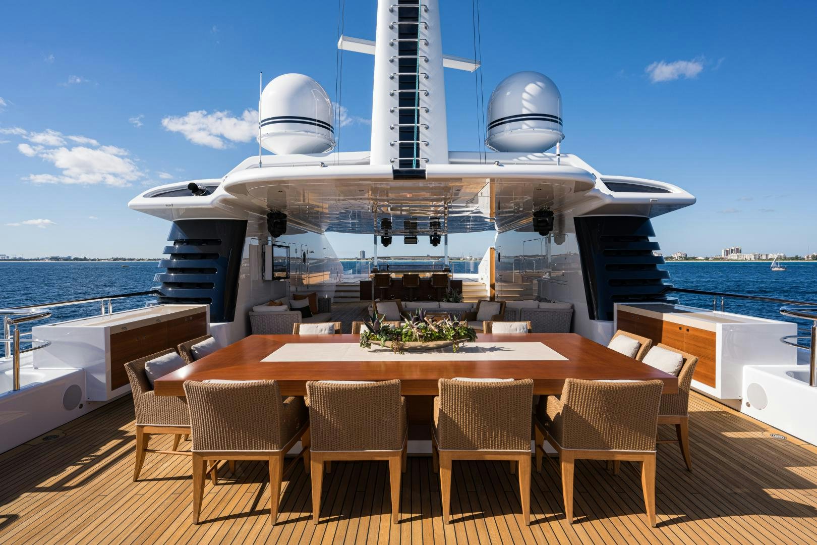 a large white ship with a table and chairs in front of it aboard QUANTUM OF SOLACE Yacht for Sale