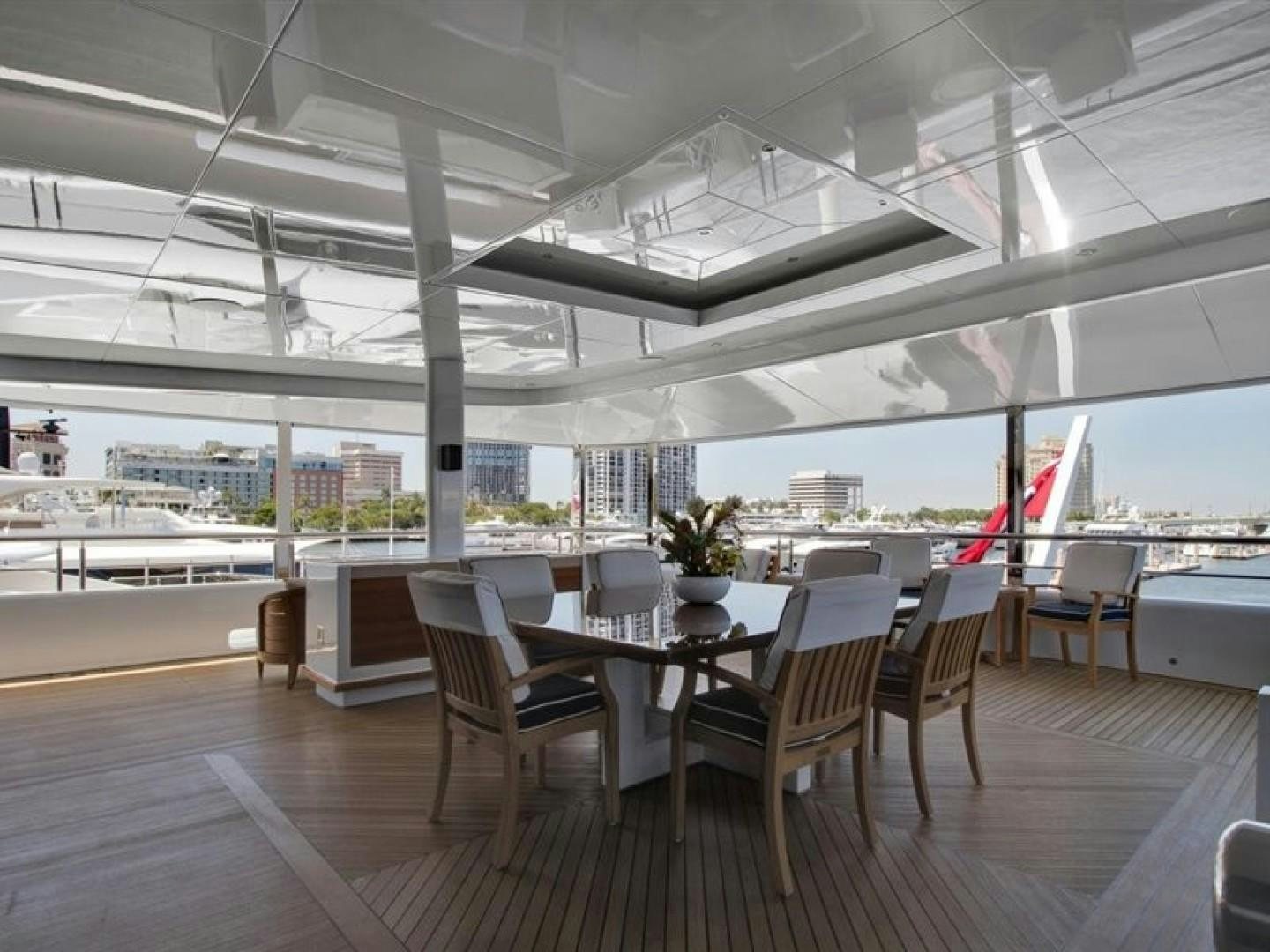 a room with tables and chairs aboard QUANTUM OF SOLACE Yacht for Sale