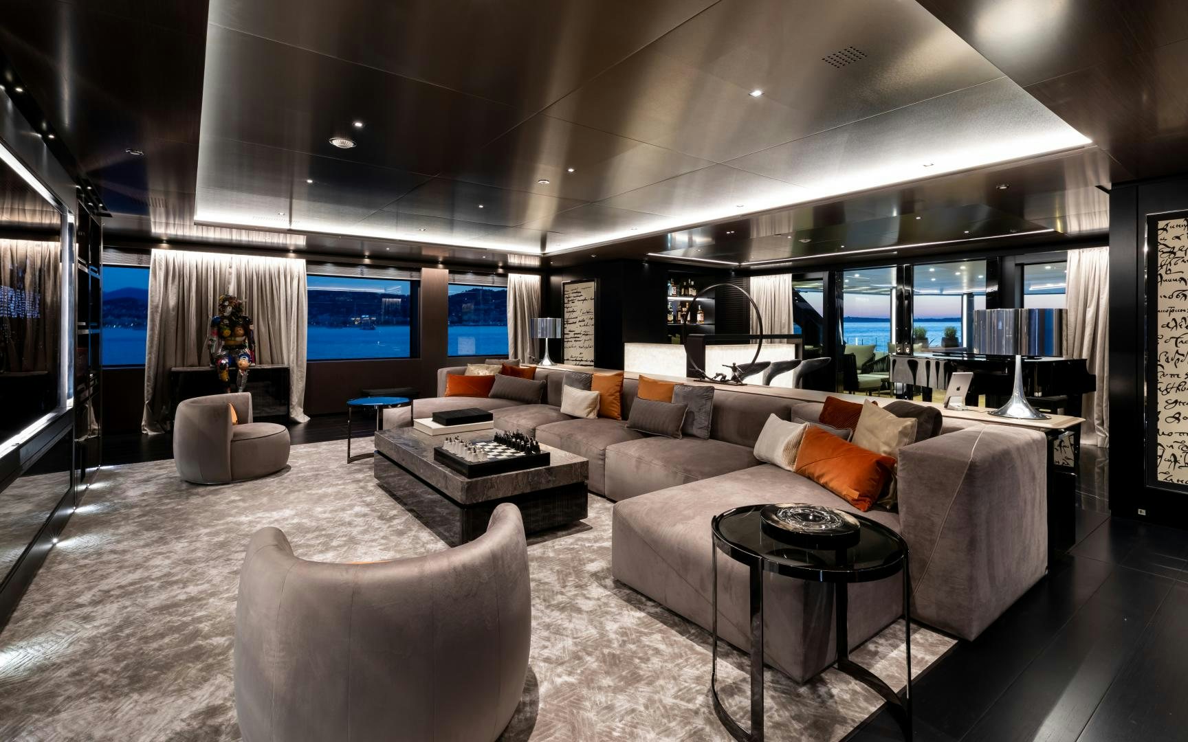 a large living room with a large white couch and a large window aboard SOLO Yacht for Sale