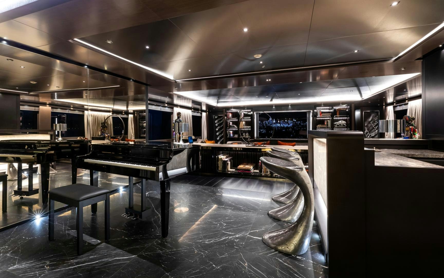 a large room with tables and chairs aboard SOLO Yacht for Sale