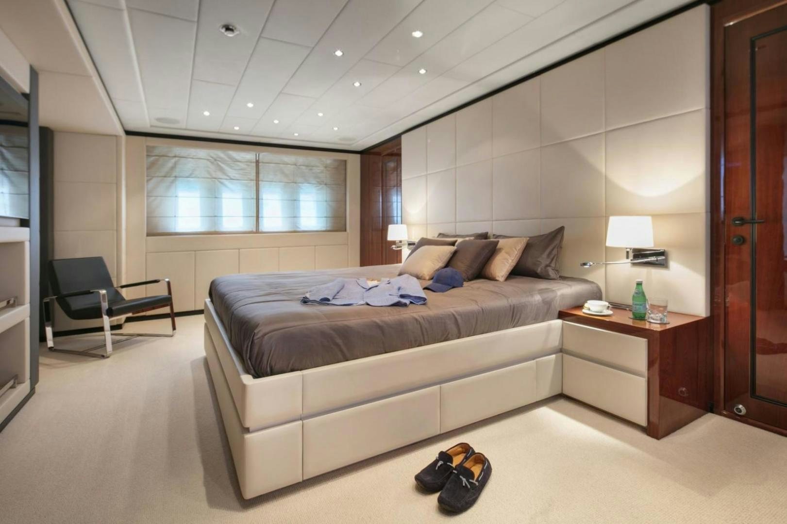 a bedroom with a bed and a desk aboard MOSKING Yacht for Sale