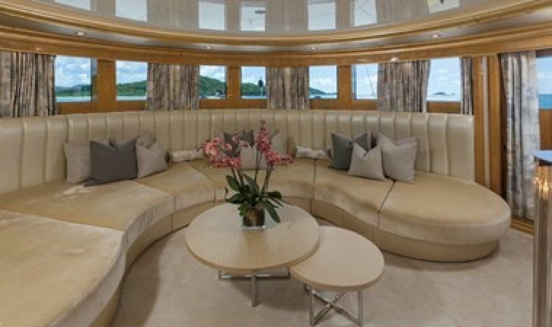 a living room with a couch and coffee table aboard ANDIAMO Yacht for Sale