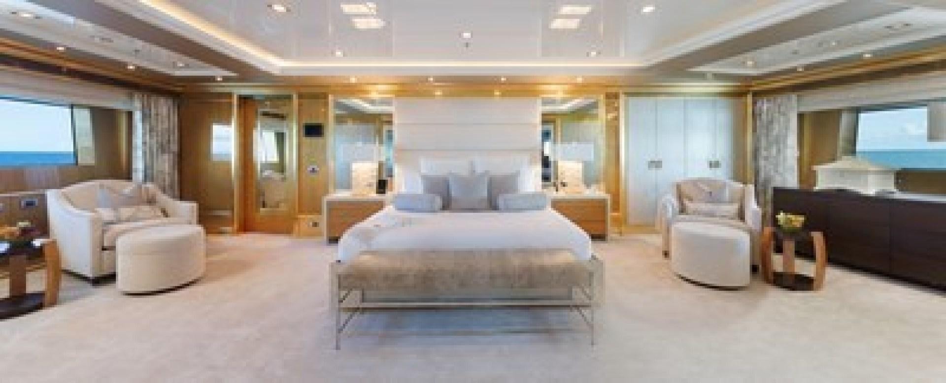 a large bedroom with a bed and a couch aboard ANDIAMO Yacht for Sale