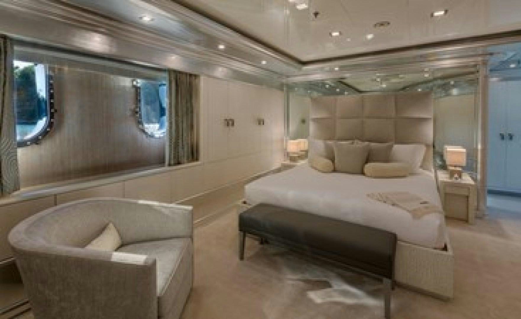 a room with a bed and a chair aboard ANDIAMO Yacht for Sale