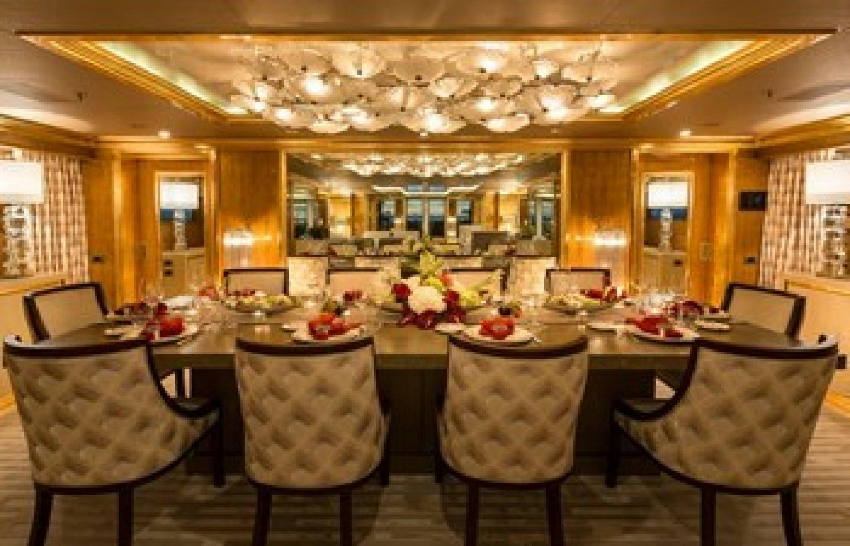 a dining room with a table set aboard ANDIAMO Yacht for Sale