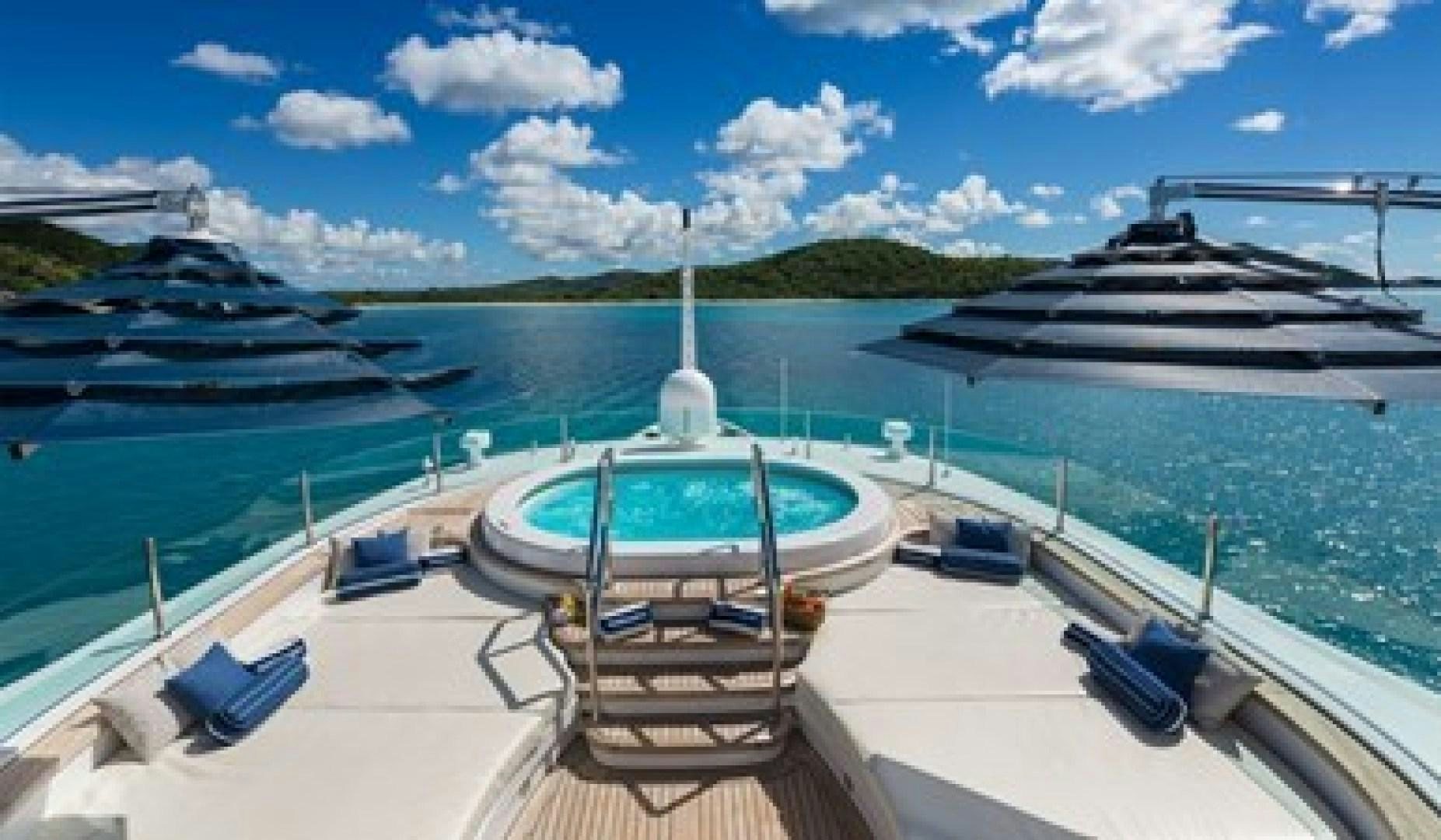 a deck with a boat and chairs on it aboard ANDIAMO Yacht for Sale