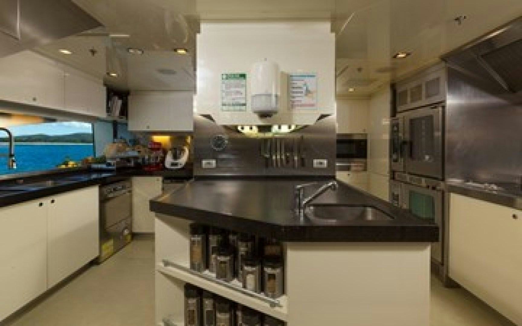 a kitchen with a sink and cabinets aboard ANDIAMO Yacht for Sale