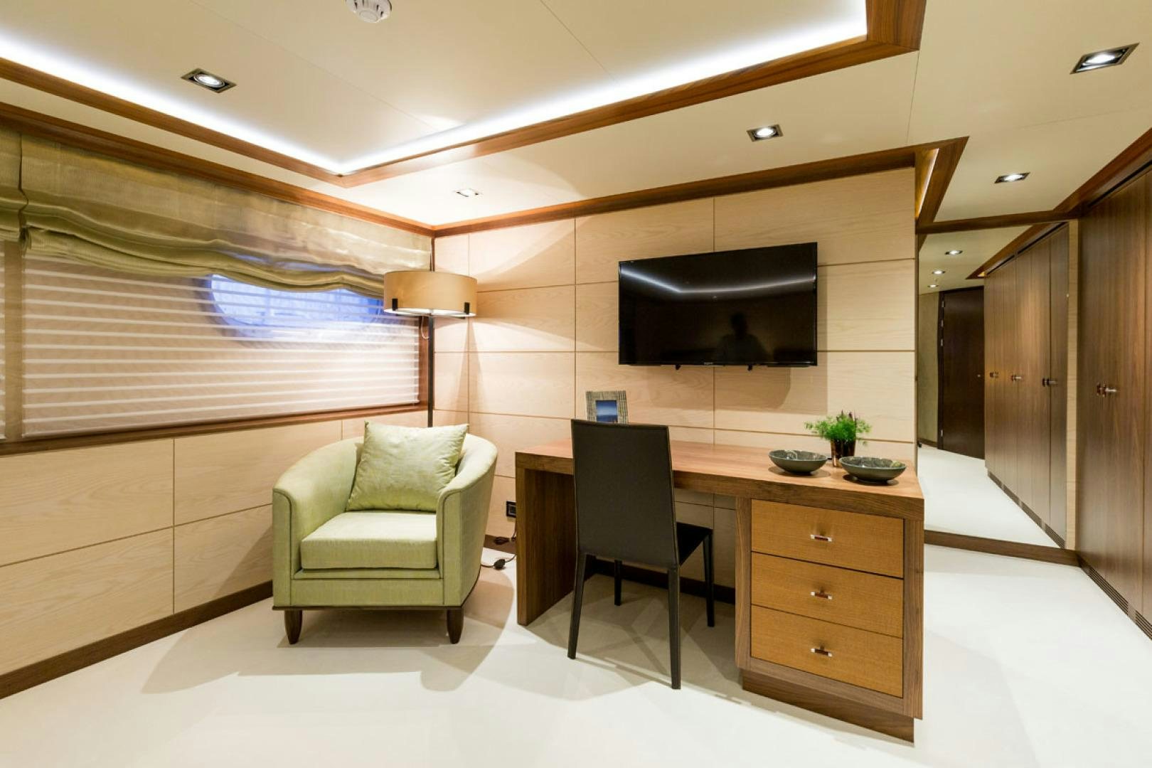 a room with a tv and a chair aboard MAYBE Yacht for Sale