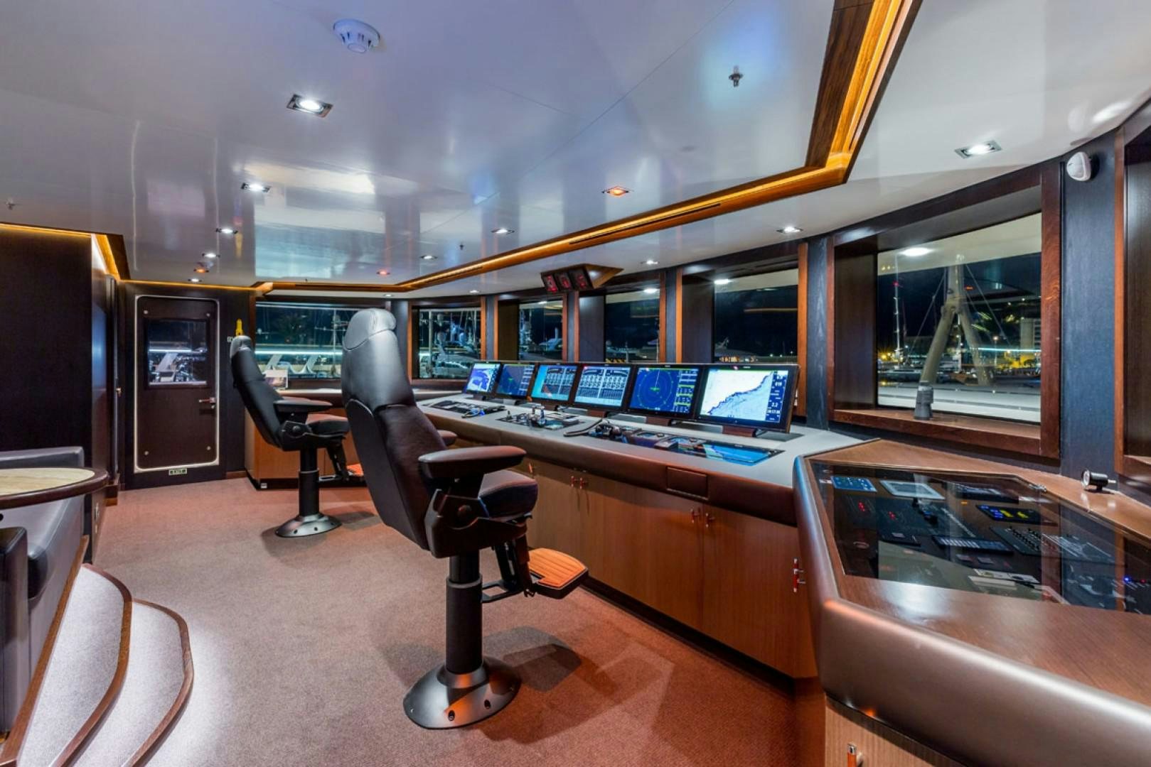 a room with a desk and chairs aboard MAYBE Yacht for Sale