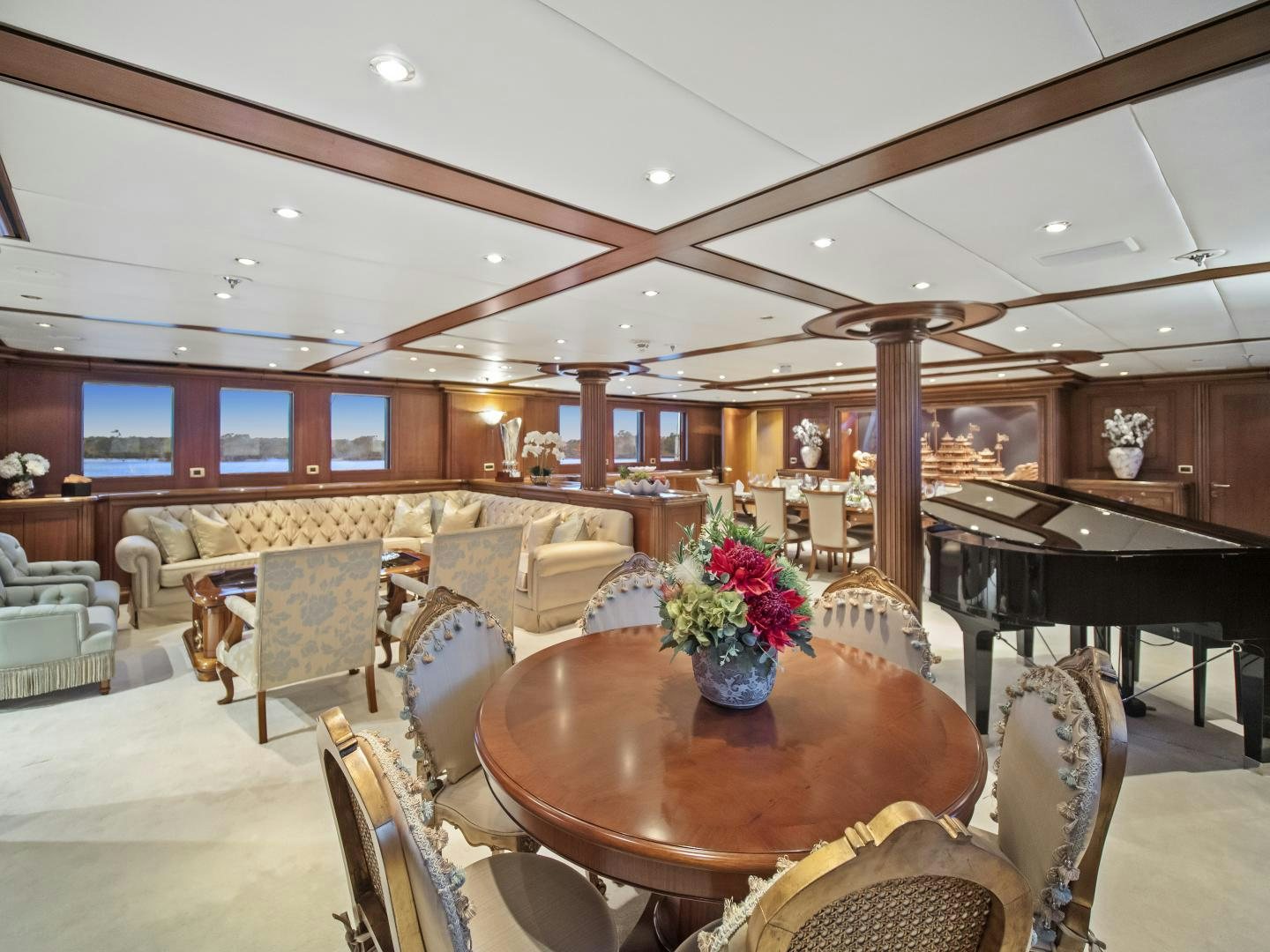 a large living room with a piano aboard THE LANGLEY Yacht for Sale