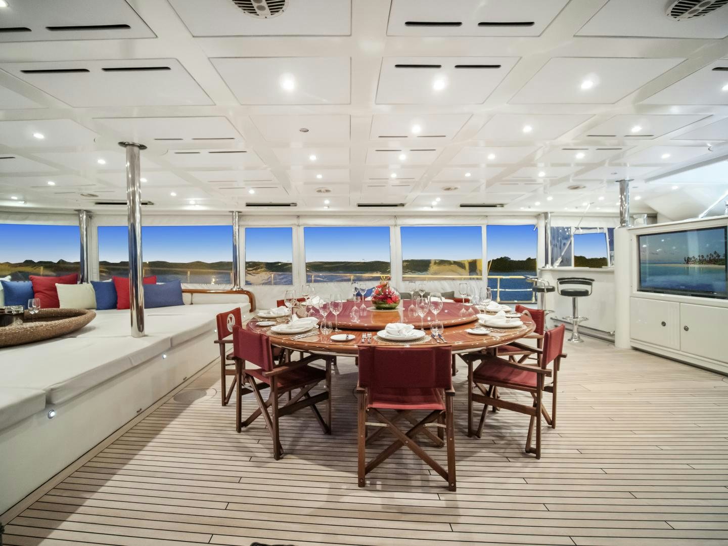 a large room with a table and chairs aboard THE LANGLEY Yacht for Sale