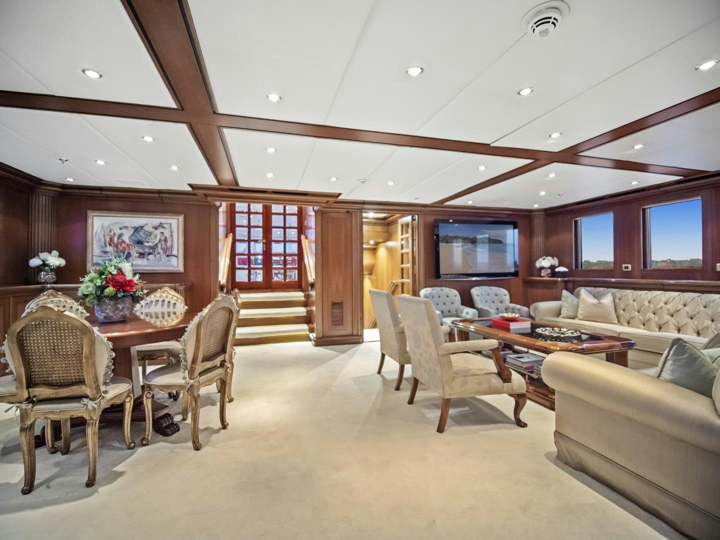 a living room with a table and chairs aboard THE LANGLEY Yacht for Sale